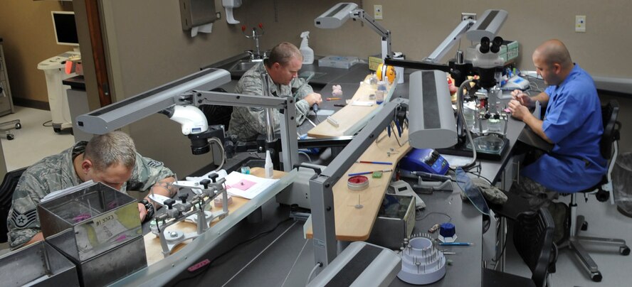 Airmen from the 2nd Dental Squadron work in the dental lab on Barksdale Air Force Base, La., Oct. 22, 2013. The dental lab performs a variety of work including fabricating and repairing complete dentures, removable partial dentures and metal or porcelain crowns. They also fix mouth guards and other types of appliances designed to restore the appearance, function and health of a patient's mouth. (U.S. Air Force photo/Senior Airman Kristin High)