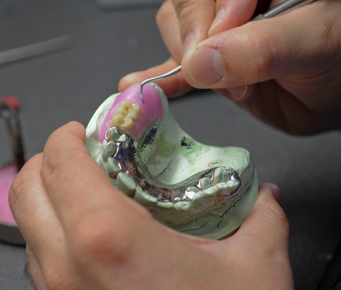 Tech. Sgt. Christopher Casey, 2nd Dental Squadron laboratory technician, builds a wax mold for artificial gums on Barksdale Air Force Base, La., Oct. 22, 2013. The wax mold will be replaced by acrylic for durability and longevity. (U.S. Air Force photo/Senior Airman Kristin High) 