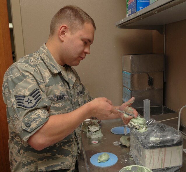 Staff Sgt. Christian Maes, 2nd Dental Squadron laboratory technician, adds plaster to create a mold in the dental lab on Barksdale Air Force Base, La., Oct. 22, 2013. The technicians create molds to help them make crowns and implants. (U.S. Air Force photo/Senior Airman Kristin High)