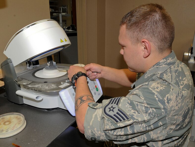 Staff Sgt. Christian Maes, 2nd Dental Squadron laboratory technician, places a glazed zirconia crown in a porcelain oven on Barksdale Air Force Base, La., Oct. 22, 2013. Glaze is added to the top of the crown to harden and create a protective coating. (U.S. Air Force photo/Senior Airman Kristin High)