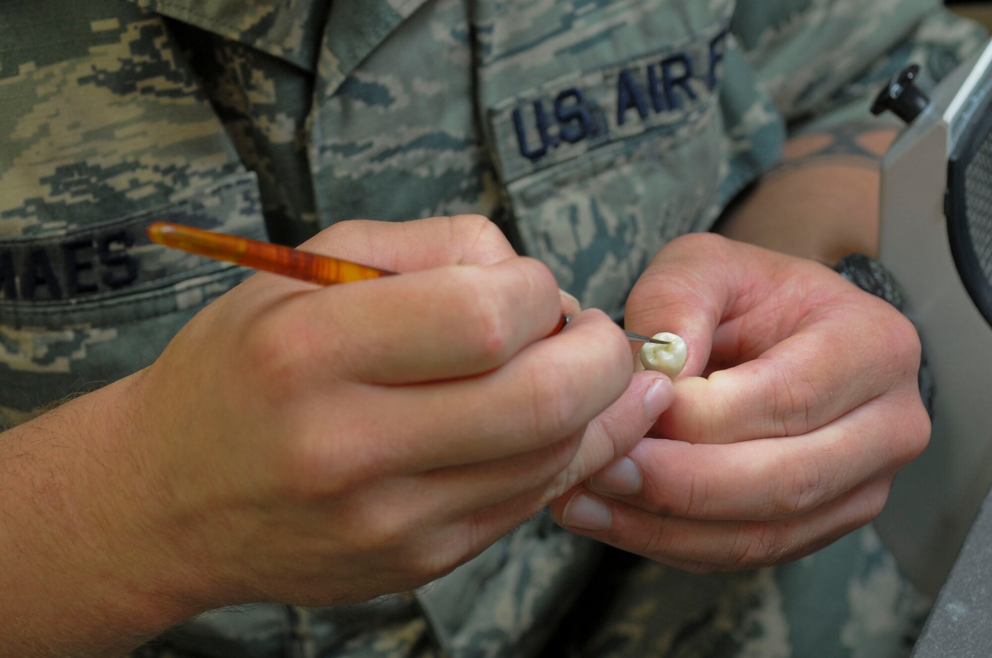 Staff Sgt. Christian Maes, 2nd Dental Squadron laboratory technician, places a glazed zirconia crown in a porcelain oven on Barksdale Air Force Base, La., Oct. 22, 2013. Glaze is added to the top of the crown to harden and create a protective coating. (U.S. Air Force photo/Senior Airman Kristin High)