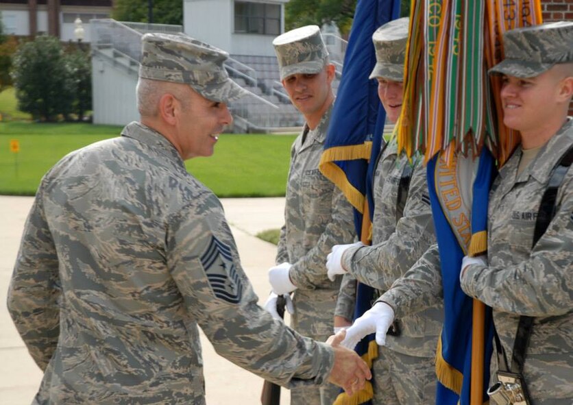 Air Force District of Washington Command Chief Master Sgt. Jose A. LugoSantiago introduces himself to members of The United States Honor Guard Colors Flight during an immersion tour at Joint Base Anacostia-Bolling, D.C., Oct. 22, 2013. The Colors Flight displays and guards the Nation's flag, U.S. Air Force flag and flags of the many visiting dignitaries' native countries. The flight presents the colors for both Air Force specific events and with other services' honor guards for joint service missions. (Courtesy photo) 