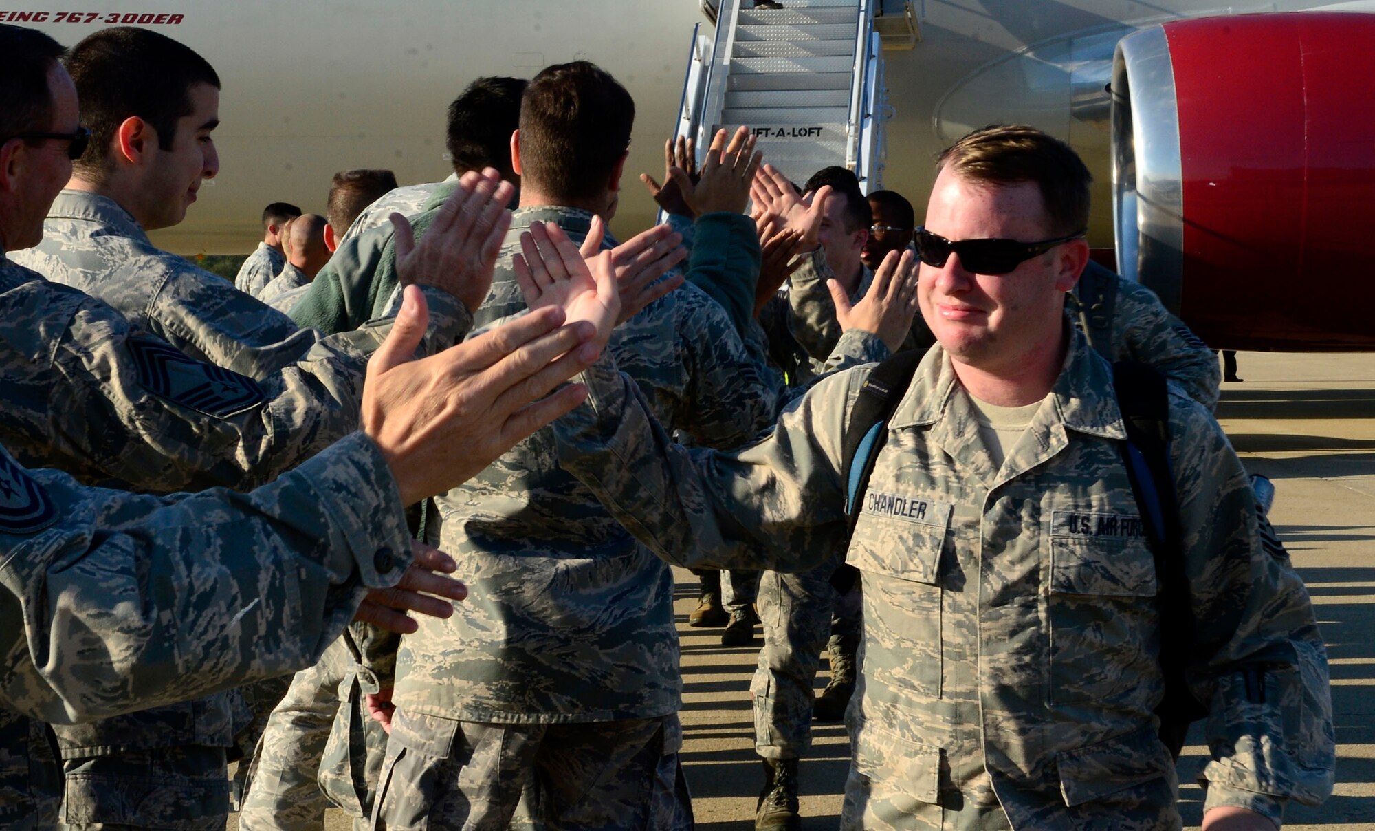 Airmen with the 27th Fighter Squadron are greeted by leadership, friends and fellow Airmen at Langley AFB, Va., Oct. 23, 2013, following a six-month deployment to Kadena Air Base, Japan. More than 300 Airmen were deployed in support of a Theater Security Package rotation where they provided stability and security while allowing units to integrate with U.S. and Japanese forces. (U.S. Air Force photo by Staff Sgt. Dana D. Flamer/Released)