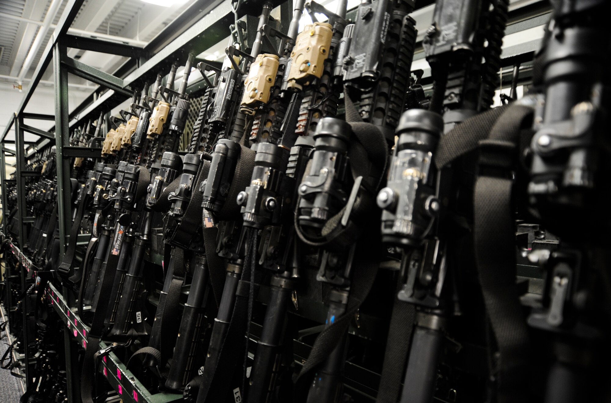 M-4 Carbines wait to be used at Davis-Monthan Air Force Base, Ariz., Oct. 23, 2013. The armory holds more than 700 government weapons and the attendant is responsible for $2.2 million dollars in equipment. (U.S. Air Force photo by Senior Airman Sivan Veazie/Released)