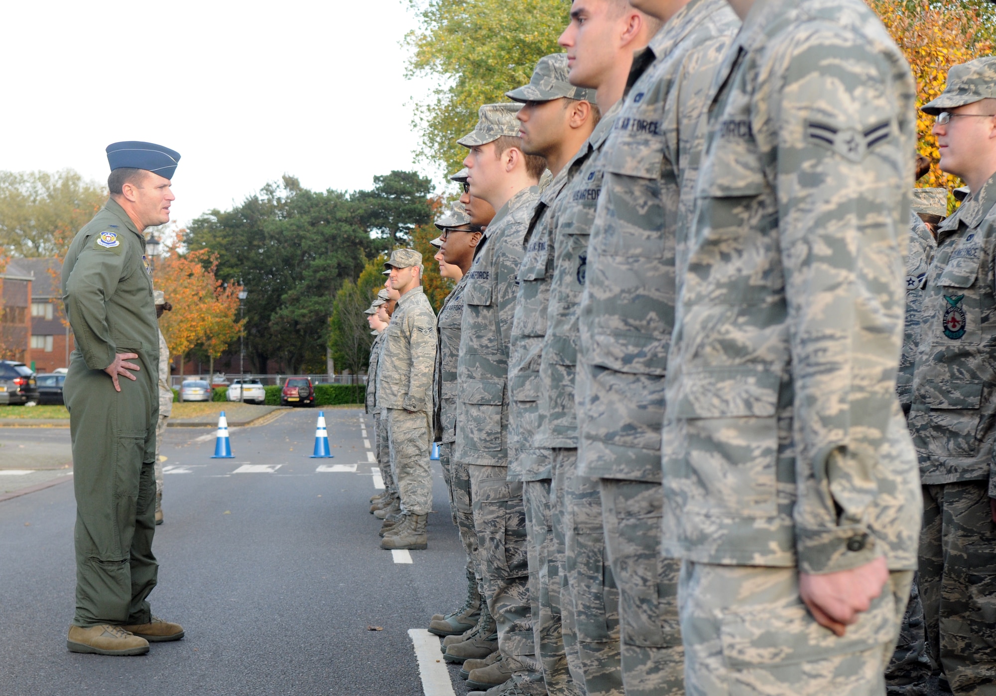 U.S. Air Force Col. Kenneth T. Bibb Jr., left, 100th Air Refueling Wing commander, speaks to Airmen participating in an Airmen-only retreat ceremony Oct. 25, 2013, on RAF Mildenhall, England. Retreat is a long-standing tradition honoring the flag and signaling the end of the duty day. A retreat ceremony, in which the U.S. flag and Royal Air Force ensign are retired, takes place on the last Friday of every month. (U.S. Air Force photo by Tech. Sgt. Austin May/Released)