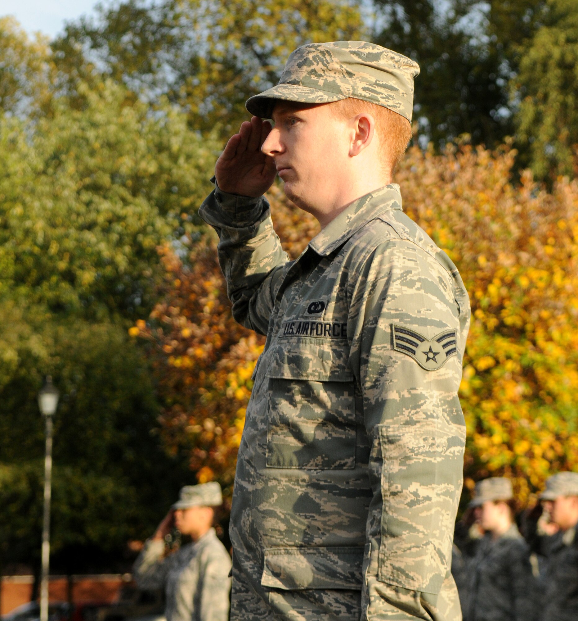 U.S. Air Force Senior Airman Casey Chase, 100th Air Refueling Wing Command Post emergency action controller, salutes the U.S. flag as it’s lowered during the monthly retreat ceremony Oct. 25, 2013, on RAF Mildenhall, England. Chase, a Fairfield, Calif., native, led the formation, which was exclusively composed of junior enlisted Airmen. Retreat is a long-standing tradition honoring the flag and signaling the end of the duty day. A retreat ceremony, in which the U.S. and Royal Air Force flags are retired, takes place on the last Friday of every month. (U.S. Air Force photo by Tech. Sgt. Austin May/Released)