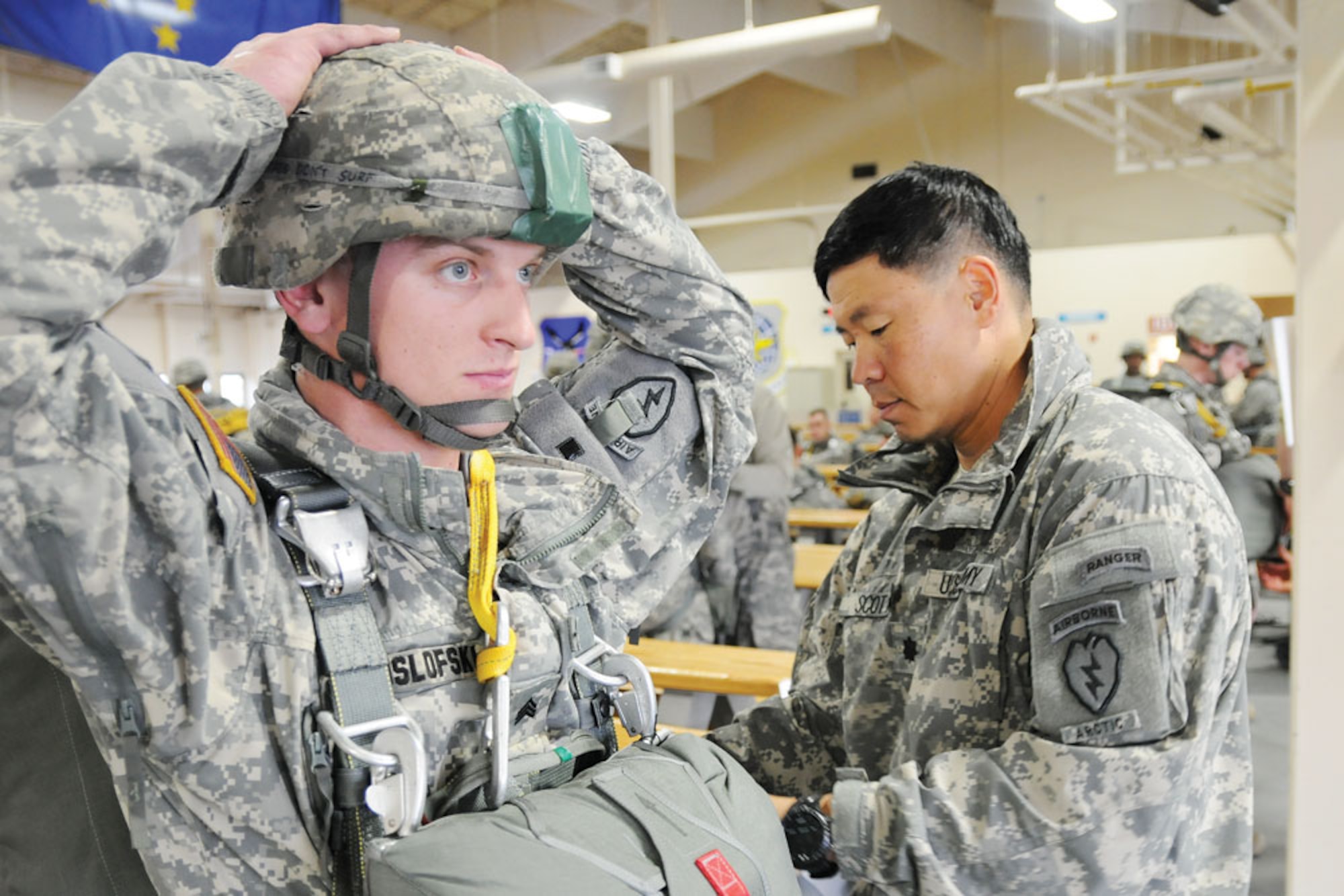 Army Lt. Col.  Richard Scott, commander of the 1st Squadron (Airborne), 40th Cavalry, inspects a Spartan paratrooper before a jump, Oct. 17, on Joint Base Elmendorf-Richardson. As a jumpmaster, Scott is responsible to ensure paratroopers are correctly rigged for a jump. (U.S. Army photo/Staff Sgt. Mark Shrewsbury)