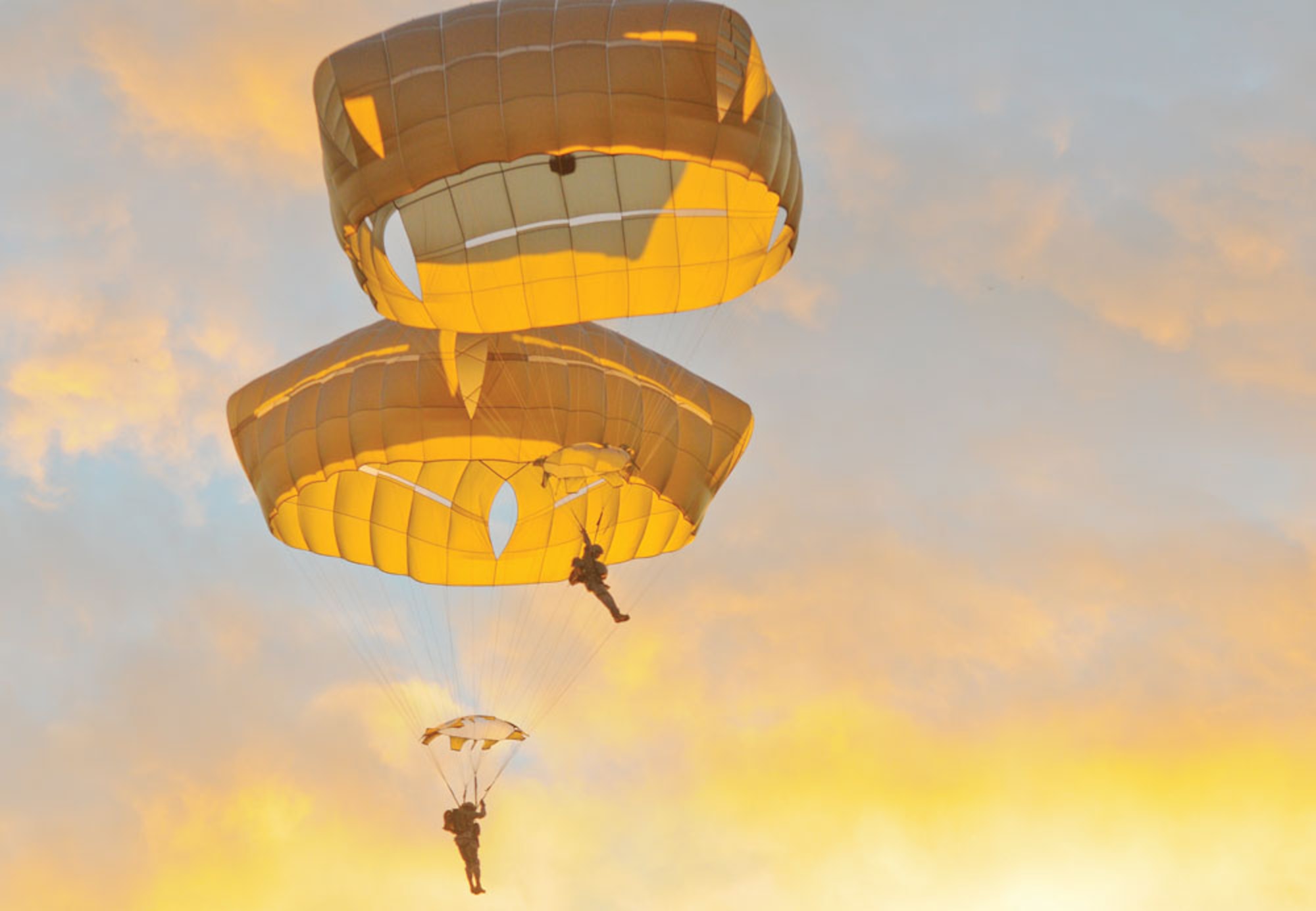 Paratroopers from the 4th Infantry Brigade Combat Team (Airborne), 25th Infantry Division, jump from a U.S. Air Force C-17 Globemaster III over Malemute Drop Zone Sept. 19. Senior leaders and riggers from the Spartan Brigade jumped from the aircraft to demonstrate confidence in the T-11 parachute as the brigade switches from the T-10. Paratroopers of the 2nd Battalion, 377th Parachute Field Artillery Battalion, and the 1st Squadron (Airborne), 40th Cavalry Regiment, jumped the parachute last week as part of a wider adoption of the system. (U.S. Army photo/Sgt. 1st Class Jason Epperson)