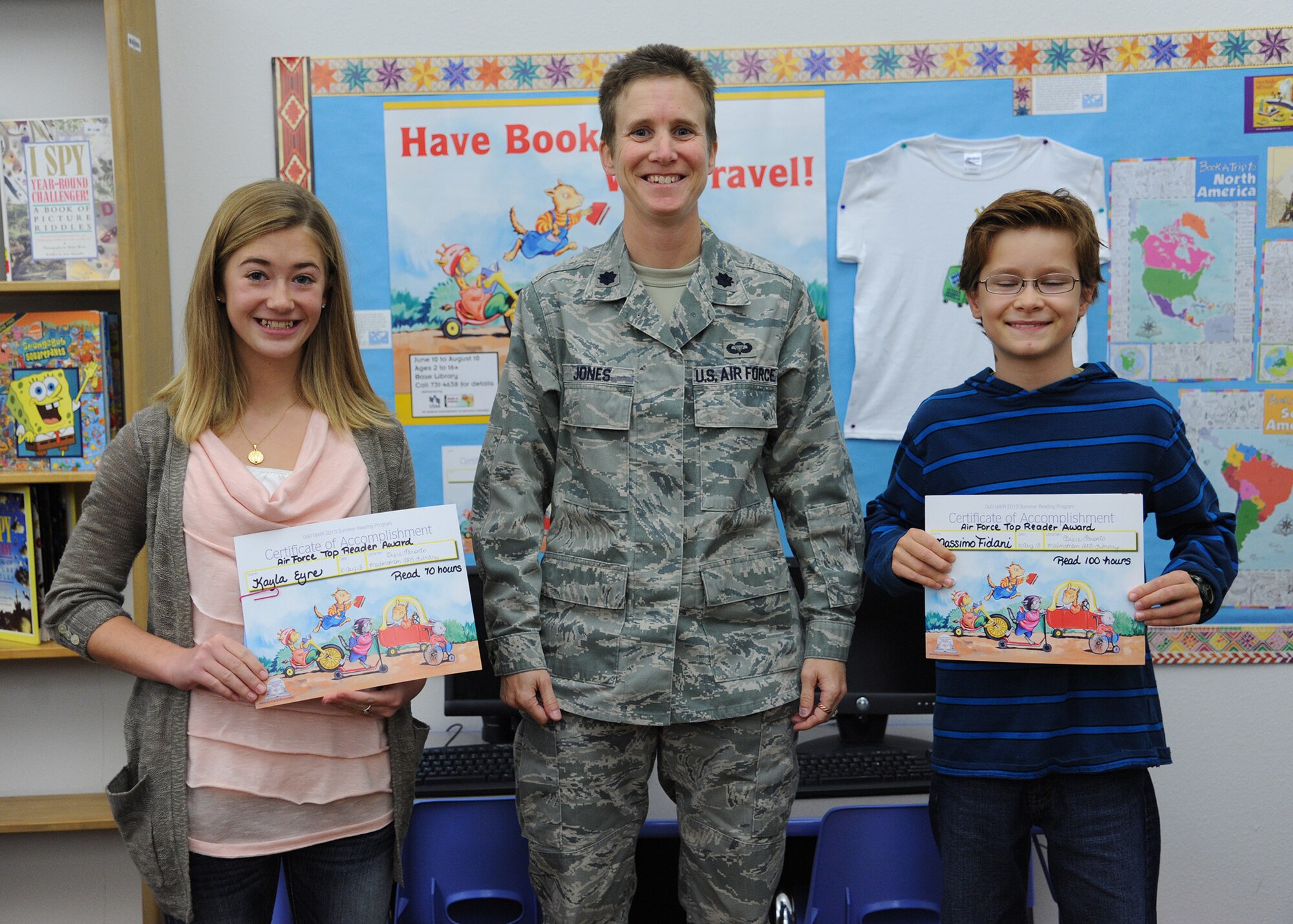 Lt. Col. Sabrina Jones, 341st Force Support Squadron commander, poses with Kayla Eyre (left), daughter of Master Sgt. Bryon Eyre, 819th RED HORSE Squadron combat arms instructor, and Massimo Fidani, son of Chief Master Sgt. Frank Fidani, 341st Missile Wing command chief, who both won in the Air Force Top Reader Contest. Eyre won the Top Young Adult Category for reading 4,200 minutes and Fidani won the Top Children Category for reading 6,000 minutes. (U.S. Air Force photo/Senior Airman Katrina Heikkinen)