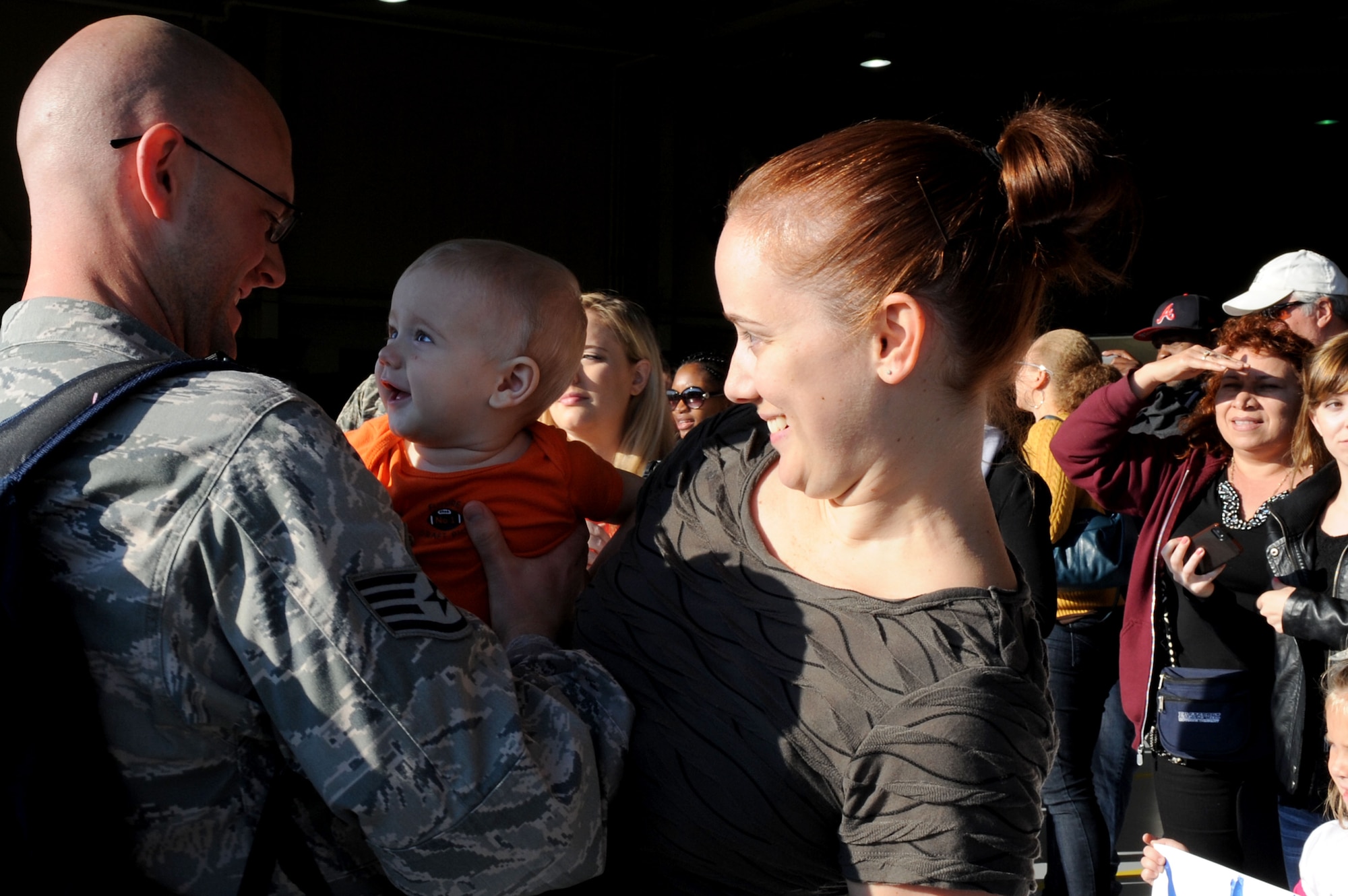U.S. Air Force Staff Sgt David Rush, 27th Fighter Squadron security manager, greets his son Jackson Rush after returning from deployment to Kadena Air Base, Japan, at Langley Air Force Base, Va., Oct. 23, 2013. During deployment, the 27th FS assisted in the integration of the U.S. Navy and Japanese Self Defense Force. (U.S. Air Force photo by Senior Airman Brittany Paerschke-O’Brien/Released)