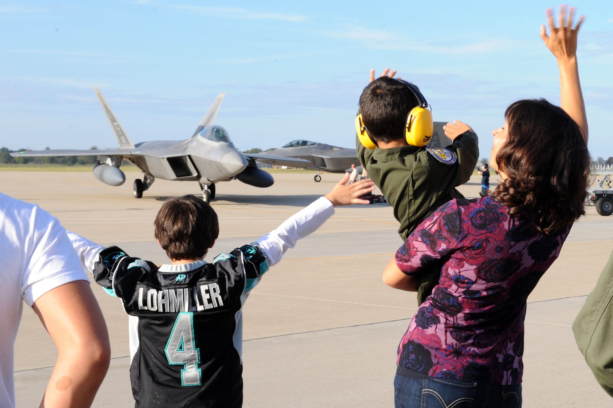 U.S. Air Force Staff Sgt. Travis Elswick, 27th Fighter Squadron munitions training manager, embraces his family at Langley Air Force Base, Va. Oct. 23, 2013, after returning from a six-month deployment. The 27th FS deployed to Kadena Air Base, Japan, in support of the Pacific Command’s Theater Security Package. (U.S. Air Force photo by Senior Airman Brittany Paerschke-O’Brien/Released)
