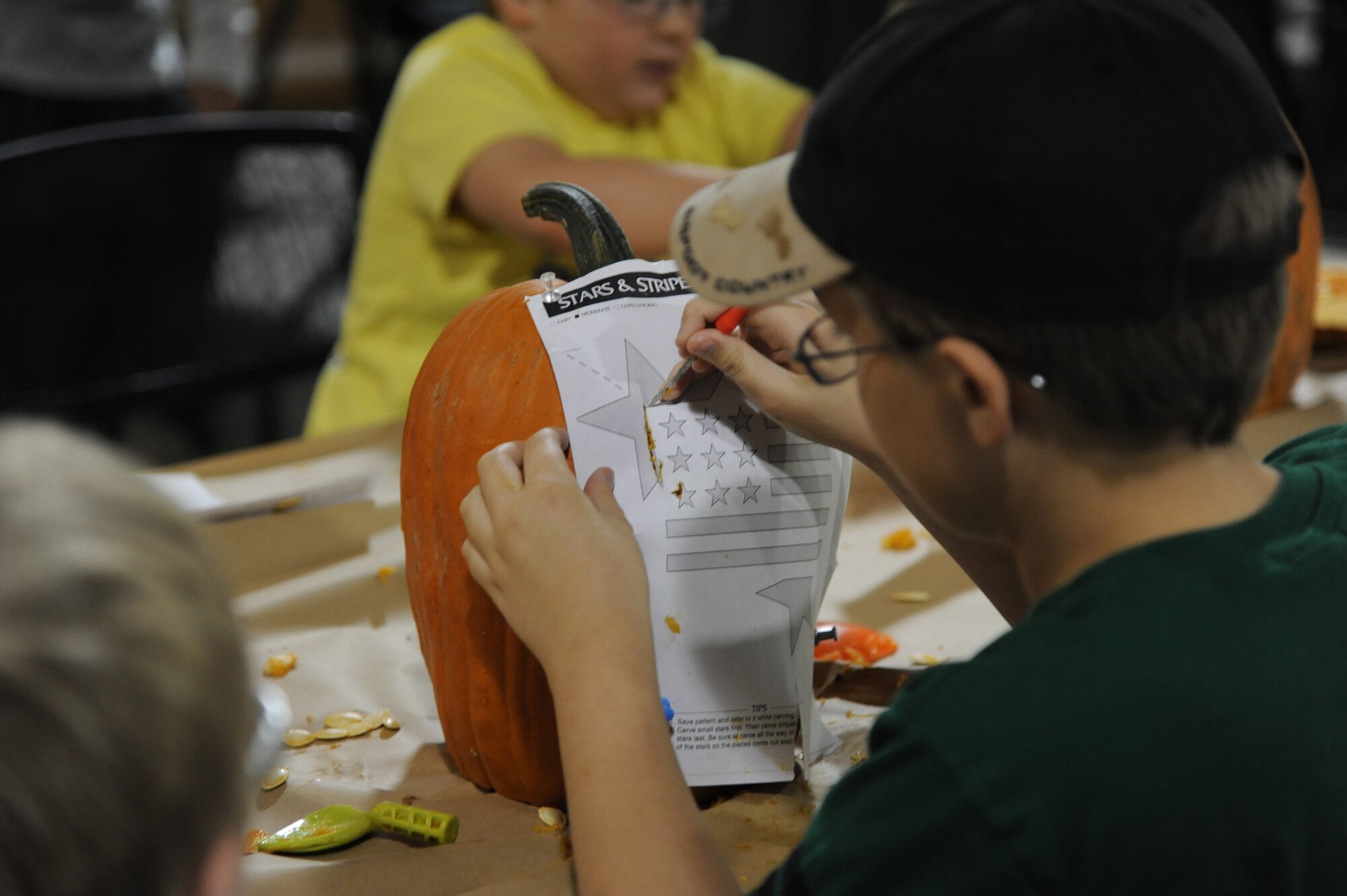 Ben McEwen, 11, starts to mark his “Stars and Stripes” carving design on a pumpkin.  McEwen was one of 22 people who attended the pumpkin carving event at the Outdoor Recreation Center on Oct. 18.  (U.S. Air Force photo/Senior Airman Cortney Paxton)