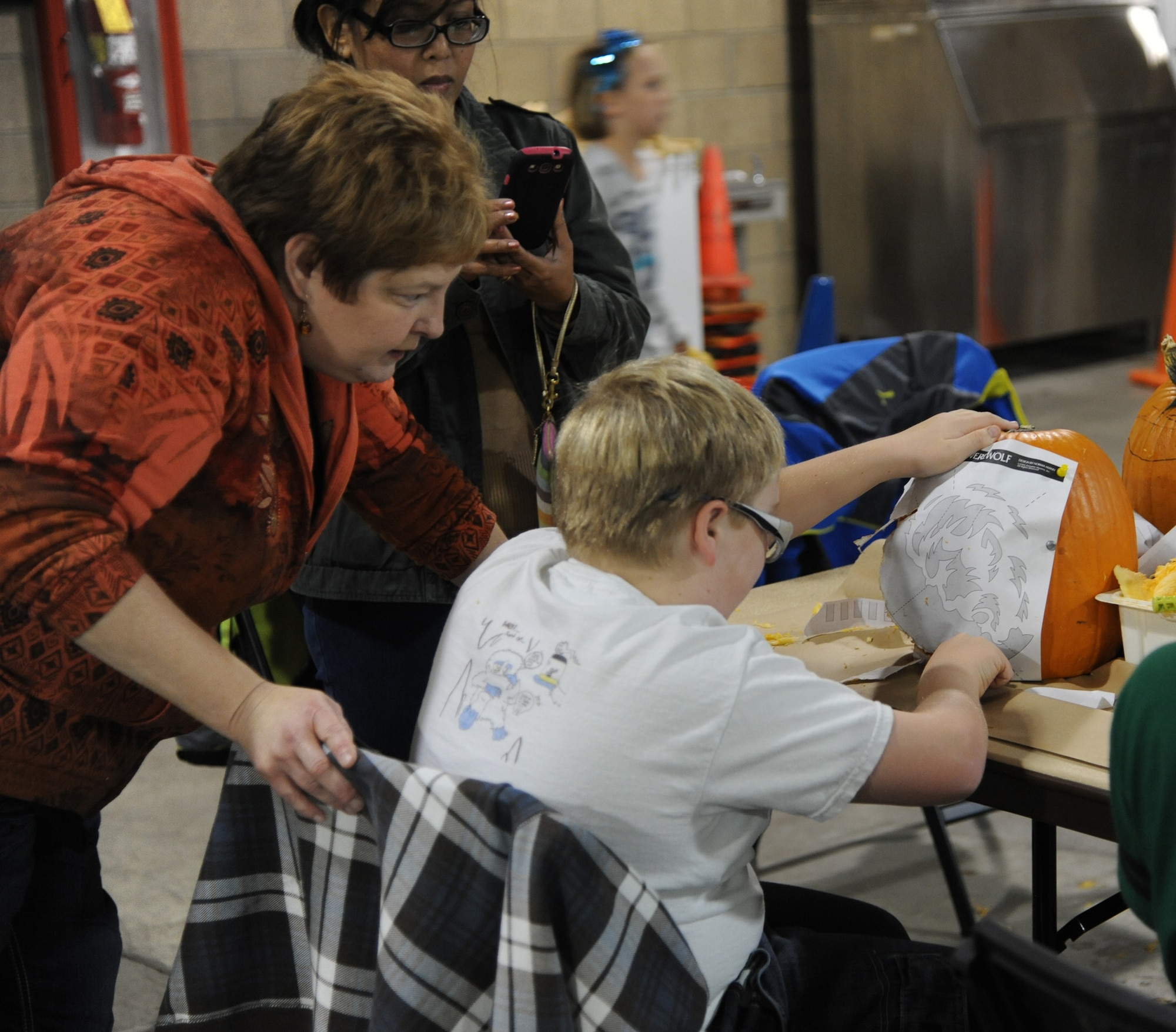 Lori Novak helps her son Jacob, 12, align a design on a pumpkin during the pumpkin carving event at the Outdoor Recreation Center on Oct. 18.  The event was the first of its kind where children and adults could carve their own pumpkins.  (U.S. Air Force photo/Senior Airman Cortney Paxton)