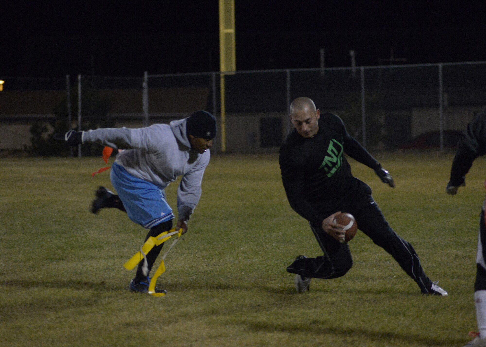 Maj. Eric Doggett, 341st Medical Support Squadron logistics and readiness flight commander, pulls the flags off Airman 1st Class Omar Ramirez, 341st Security Forces Group member, during the first quarter of the 341st Medical Group versus 741st Missile Security Forces Squadron Tactical Response Force game Oct. 17.  More than 100 Team Malmstrom members participated in this year’s flag-football season. (U.S. Air Force photo/Airman 1st Class Collin Schmidt)