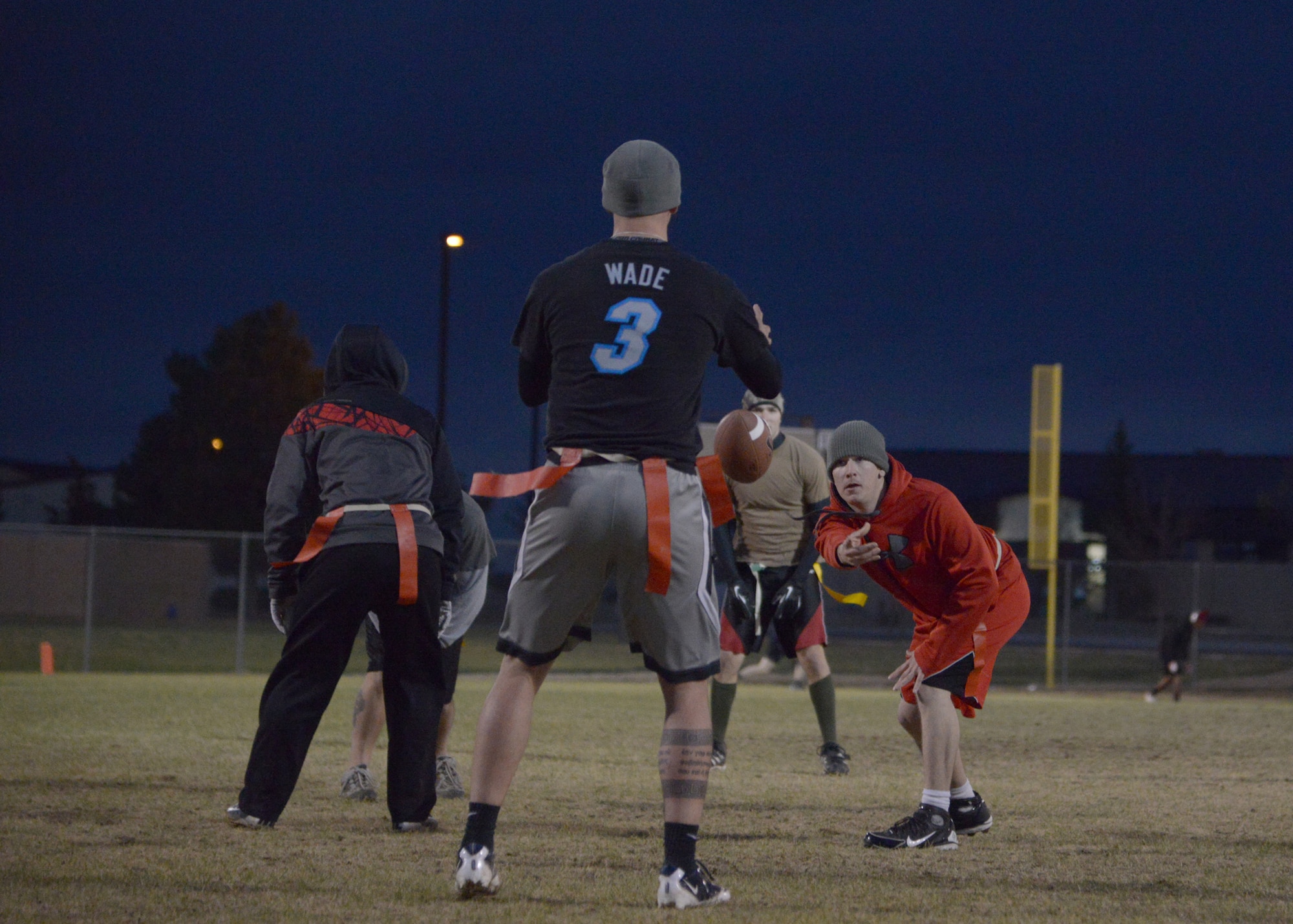 Airman 1st Class Brady Castellano, 341st Civil Engineer Squadron knowledge operator, throws a pass to his teammate during the second quarter of the 341st CES versus 341st Maintenance Group game Oct. 17. The final score of the game was 28 to 19 with the 341st MXG taking the win. (U.S. Air Force photo/ Airman 1st Class Collin Schmidt)
