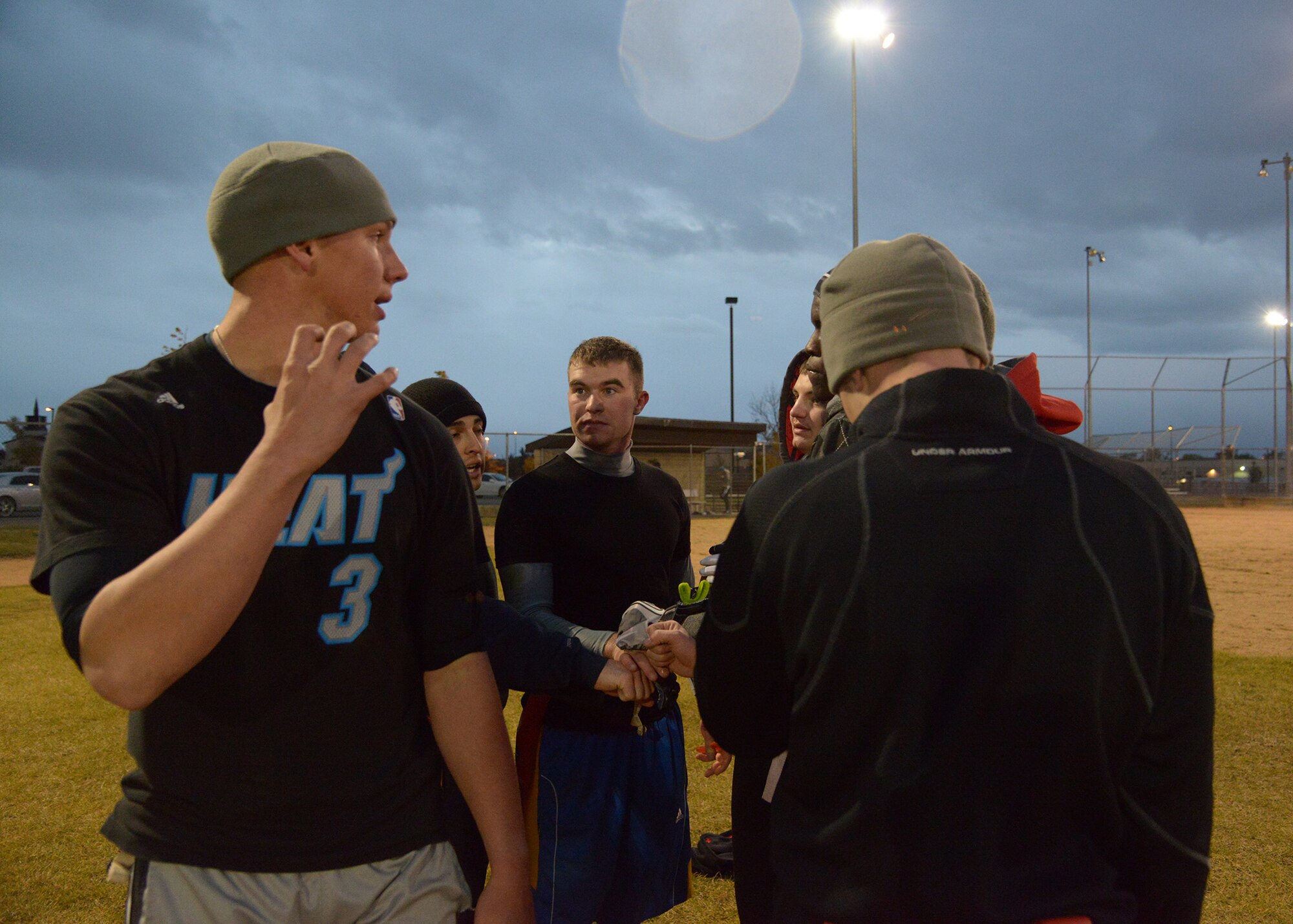 Airman 1st Class Brady Castellano, 341st Civil Engineer Squadron knowledge operator (left), reviews plays in a huddle that did and did not work during the first half of the 341st CES versus 341st Maintenance Group game with his teammates Oct. 17. In total, 14 teams participated in this year’s flag-football season. (U.S. Air Force photoAirman 1st Class Collin Schmidt)