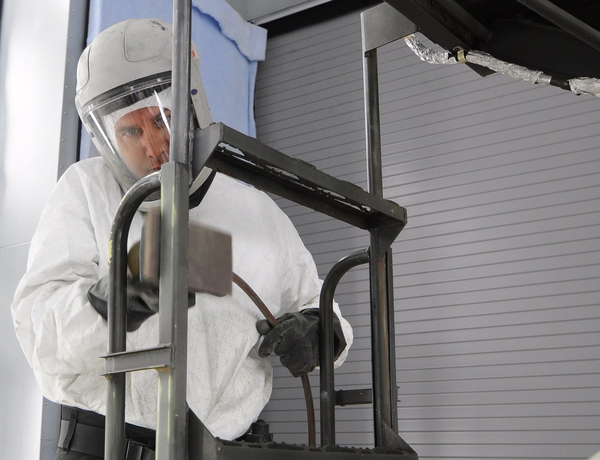 Staff Sergeant Derek Bryant, 507th Sheet Metal Shop, sands a B-4 stand in the new paint booth.  This is the first piece of aerospace ground equipement (AGE) to go through the corrosion test and painting process in the new facility.  The sheet metal shop begins the process of converting all AGE equipment from green to gray.  (U.S. Air Force photo/Senior Airman Mark Hybers)