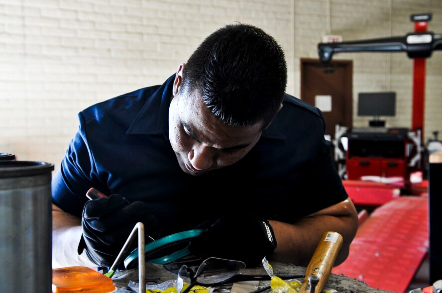 Airman 1st Class Michael Shirley, 56th Logistics Readiness Squadron maintenance mechanic journeyman, fixes a crank shaft seal Wednesday in the vehicle maintenance building. (U.S. Air Force photo/Senior Airman David Owsianka)