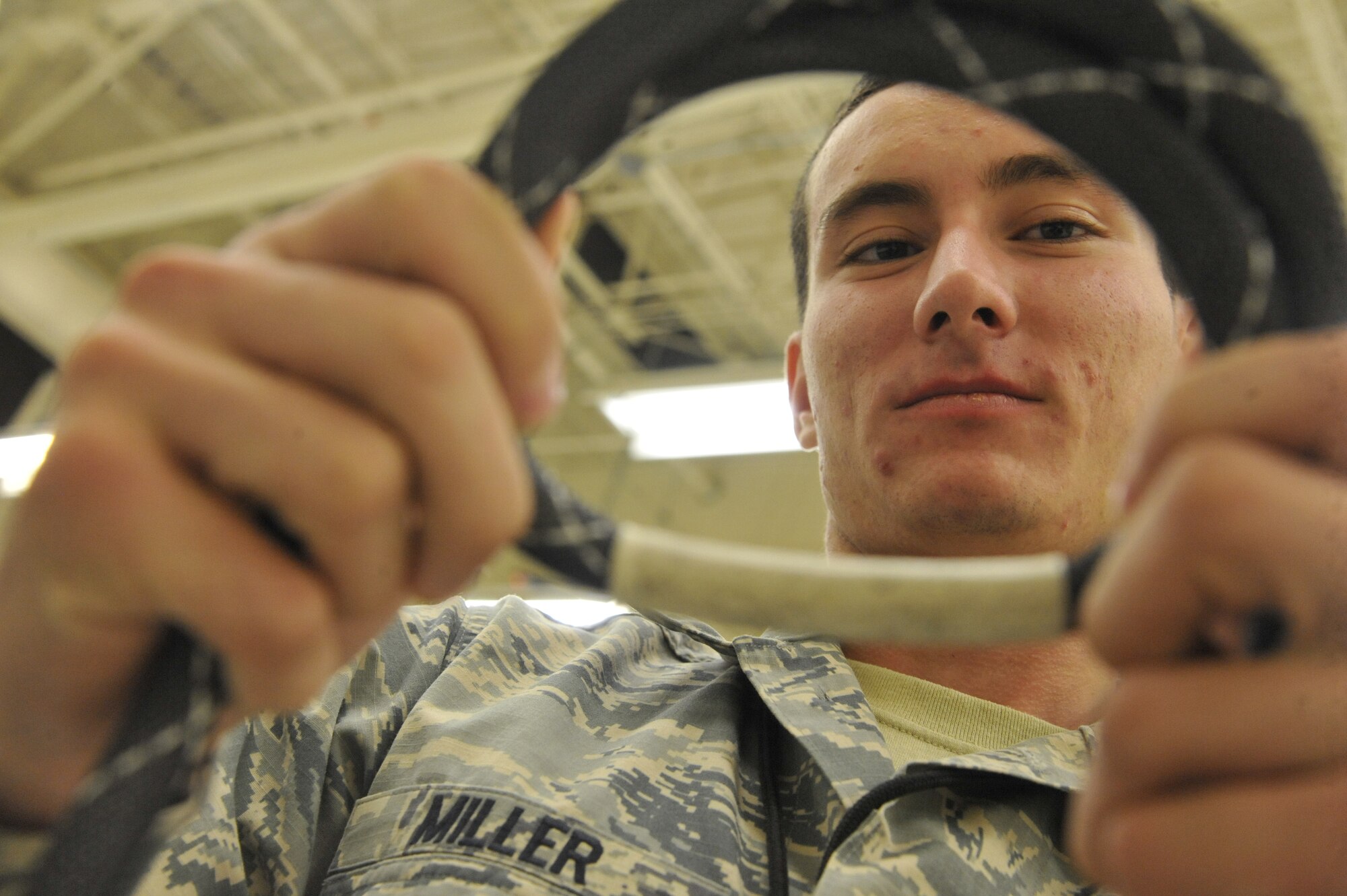 U.S. Air Force Airman 1st Class Airman 1st Class Michael Miller, 509th Maintenance Squadron electrical environment technician, inspects a wire bundle at Whiteman Air Force Base, Mo., Oct. 15, 2013. The wire bundle is used to connect components to the break-out box during bench checks. (U.S. Air Force photo by Airman 1st Class Keenan Berry/Released)