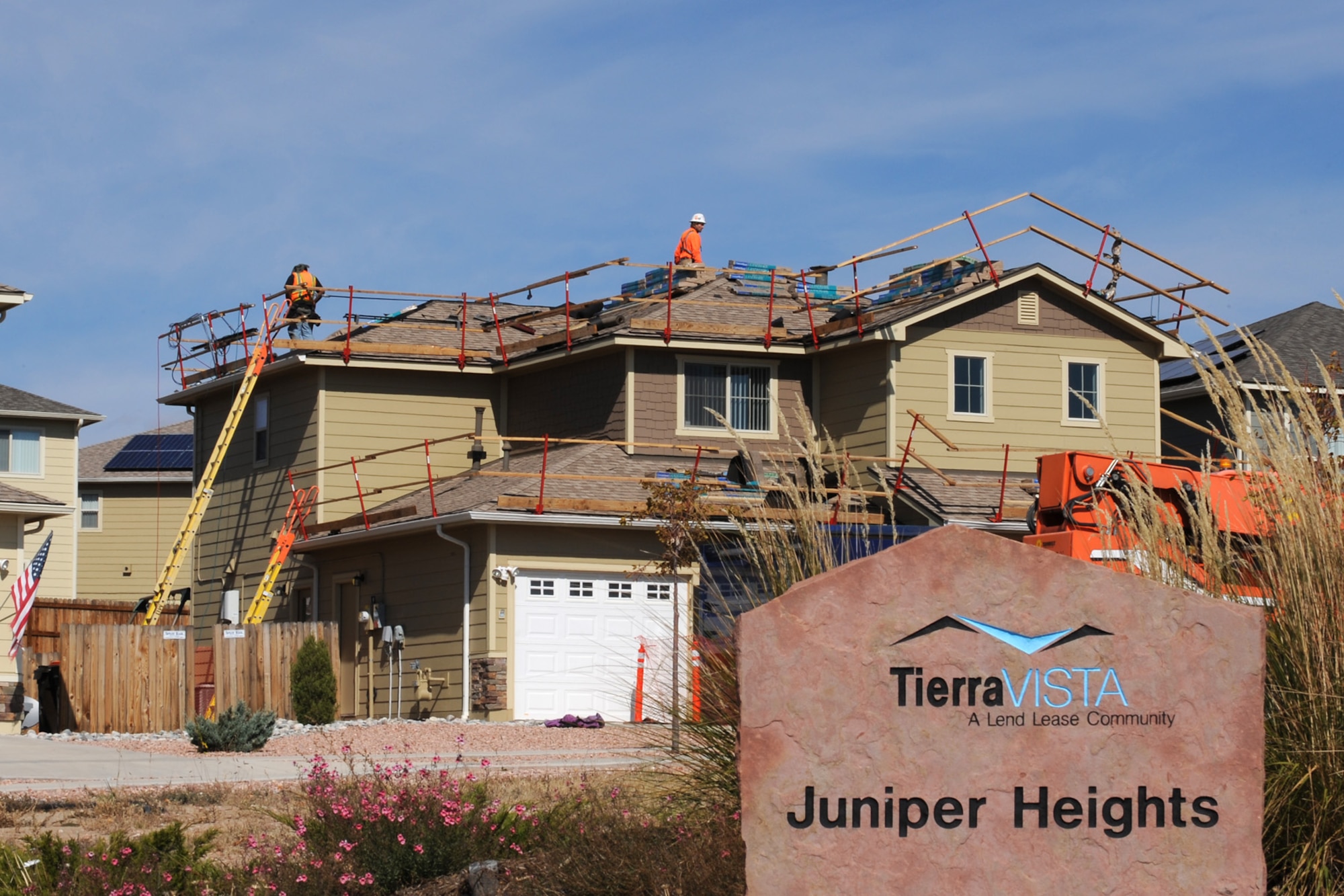 PETERSON AIR FORCE BASE, Colo. – Contractors at Tierra Vista Communities scale the rooftop of a residence in base housing to test solar panels that were installed over the summer. The panels were installed as part of a 20-year lease that is expected to save more than $1.1 million in energy costs. These savings will provide additional funds for neighborhood improvements. (U.S. Air Force photo/Staff Sgt. Aaron Breeden)