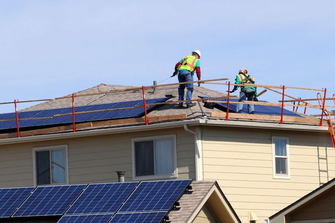 PETERSON AIR FORCE BASE, Colo. – Contractors at Tierra Vista Communities scale the rooftop of a residence in base housing to test solar panels that were installed over the summer. The panels were installed as part of a 20-year lease that is expected to save more than $1.1 million in energy costs. These savings will provide additional funds for neighborhood improvements. (U.S. Air Force photo/Staff Sgt. Aaron Breeden)