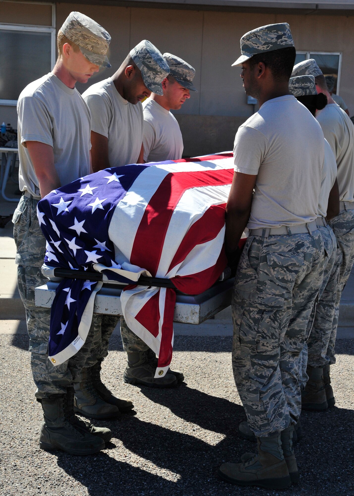 Honor Guard members move a mock casket during a six-man retirement sequence. Luke Honor Guard personnel train for funerals, color guards, flag raisings, sword cordons and more. (U.S. Air Force photo/Senior Airman Grace Lee)