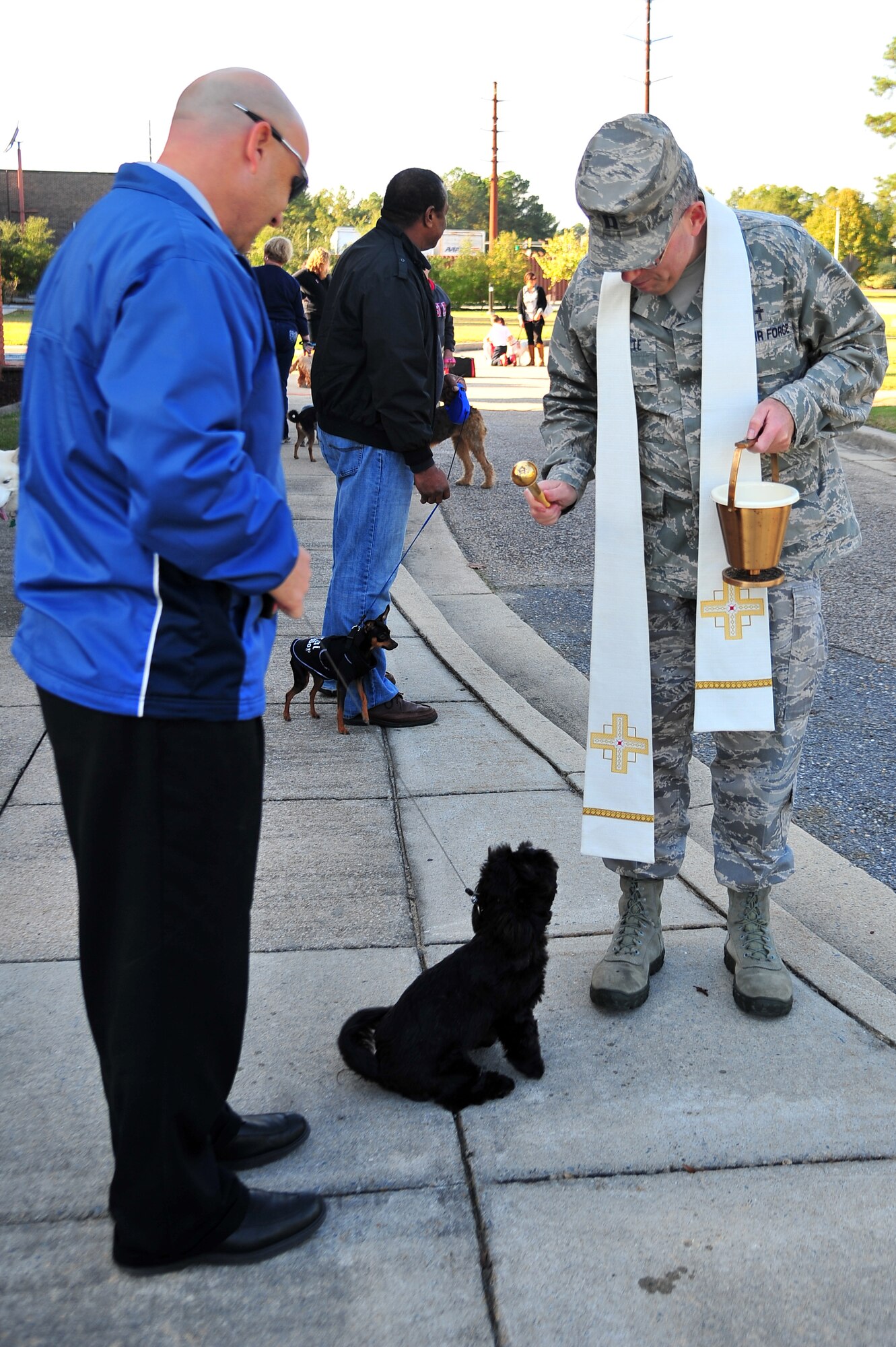 U.S. Air Force Chaplain (Capt.) Jesus Navarrete, 4th Fighter Wing chaplain, sprinkles a dog with holy water during the Blessing of Pets ceremony at Seymour Johnson Air Force Base, N.C., Oct. 24, 2013. According to Navarrete, it is traditional for members of the Catholic Church to gather their critters to be prayed upon during the feast of St. Francis of Assisi, patron saint of animals. (U.S. Air Force photo by Senior Airman Aubrey White)