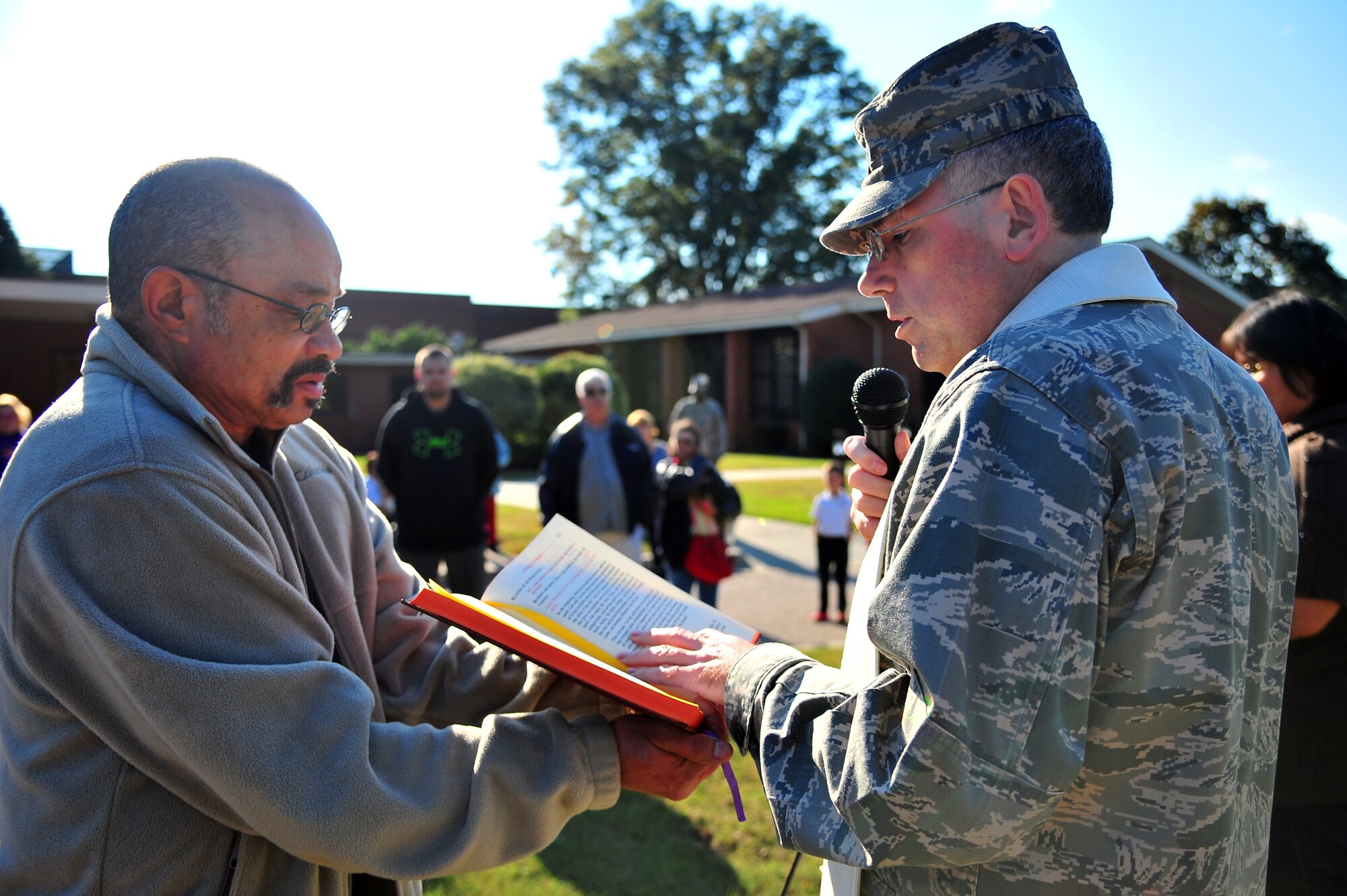 U.S. Air Force Chaplain (Capt.) Jesus Navarrete, 4th Fighter Wing chaplain, recites a passage from the Bible during the Blessing of Pets ceremony at Seymour Johnson Air Force Base, N.C., Oct. 24, 2013. According to Navarrete, it is customary for animals to be prayed over during October in remembrance of St. Francis of Assisi, patron saint of animals, who had a love for all creatures. More than 20 cats and dogs attended the ceremony with their owners. (U.S. Air Force photo by Senior Airman Aubrey White)