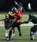 Shane Sheppard, 1st Special Operations Force Support Squadron wide receiver, is swarmed by 1st Special Operations Logistics Readiness Squadron defensive backs after catching a pass during the final game of the Intramural Flag Football Tournament at Hurlburt Field, Fla., Oct. 18, 2013. The LRS stepped up their defense in the second half to tie the game, 26-26, before going into overtime. (U.S. Air Force photo/Senior Airman Kentavist P. Brackin)