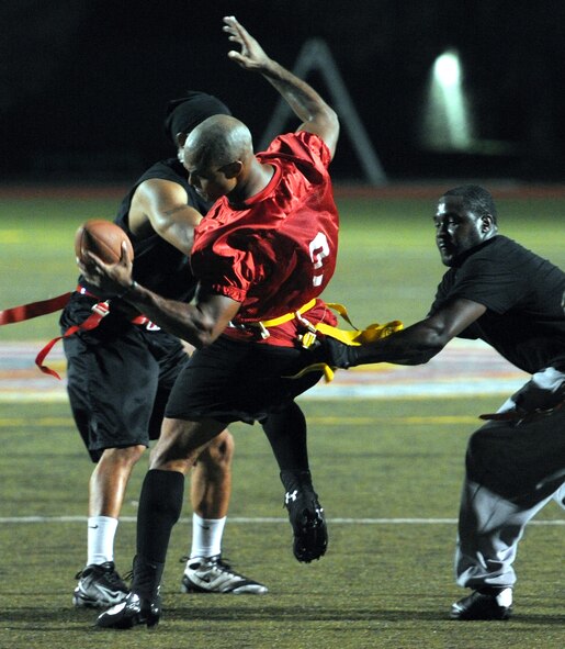 Shane Sheppard, 1st Special Operations Force Support Squadron wide receiver, is swarmed by 1st Special Operations Logistics Readiness Squadron defensive backs after catching a pass during the final game of the Intramural Flag Football Tournament at Hurlburt Field, Fla., Oct. 18, 2013. The LRS stepped up their defense in the second half to tie the game, 26-26, before going into overtime. (U.S. Air Force photo/Senior Airman Kentavist P. Brackin)