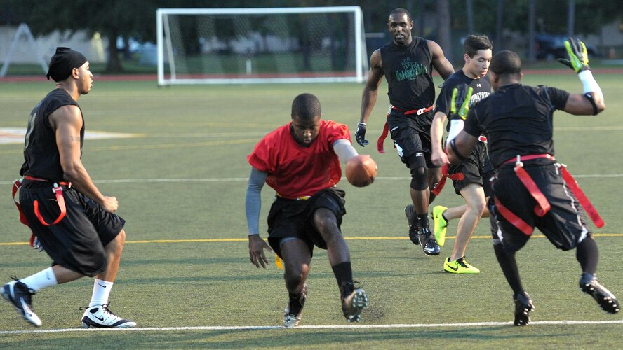 Derrick Raley, 1st Special Operations Forces Support Squadron quarterback, dashes in for a touchdown during the final game of the Intramural Flag Football Tournament at Hurlburt Field, Fla., Oct. 18, 2013. The FSS kept the lead, ending the first half, 19-15, against the 1st Special Operations Logistics Readiness Squadron. (U.S. Air Force photo/Senior Airman Kentavist P. Brackin)