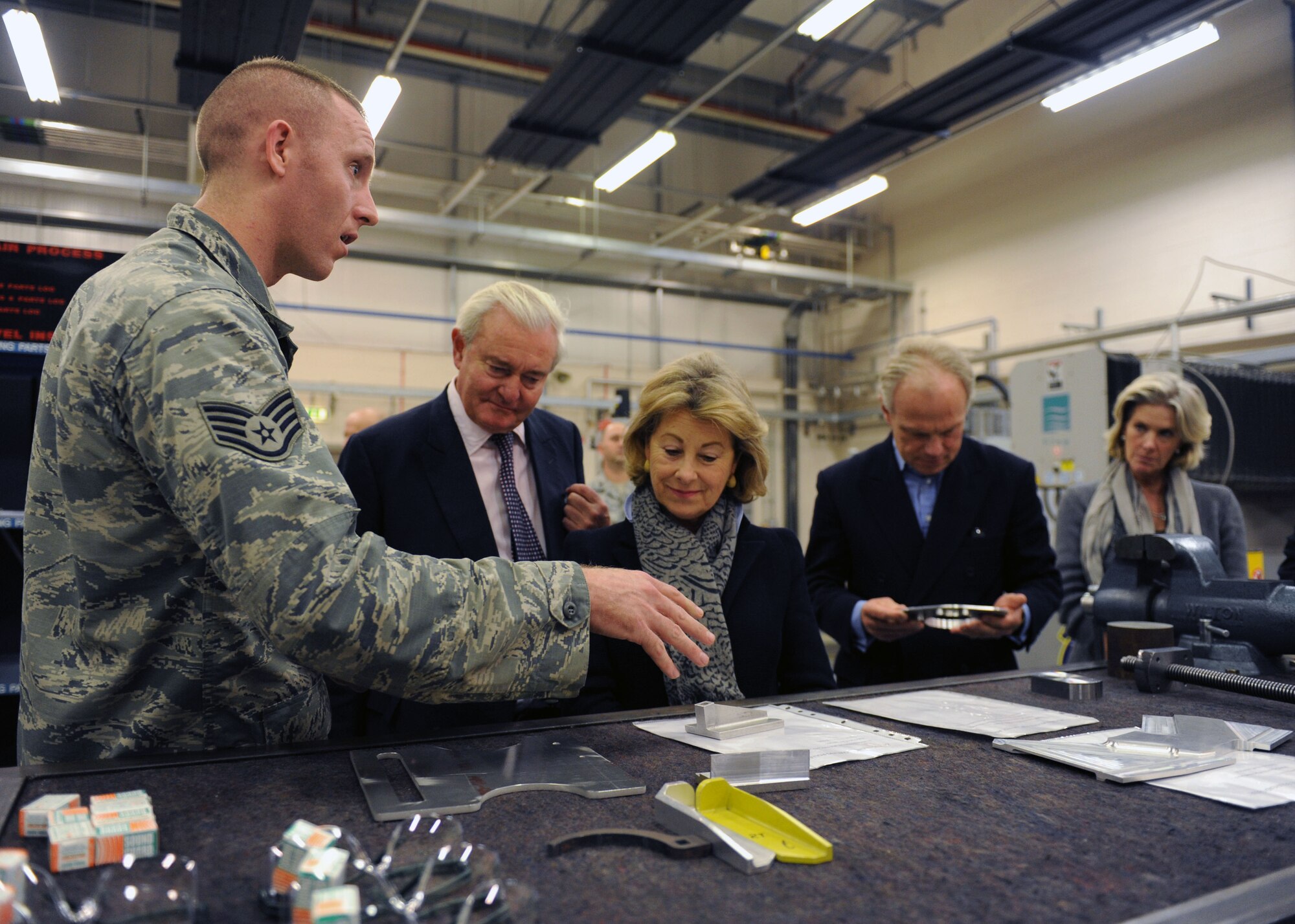U.S. Air Force Staff Sgt. Aaron Lynch, left, 100th Maintenance Squadron aircraft metals technology shift supervisor, shows aircraft grounding-wire reels and other aircraft parts to local high sheriffs and their spouses Oct. 23, 2013, on RAF Mildenhall, England. The 100th Maintenance Group shops gave the high sheriffs a hands-on view of how they support the Team Mildenhall mission. 
The distinguished guests had the opportunity to visit the base and meet some of the service members stationed here. (U.S. Air Force photo by Airman 1st Class Preston Webb/Released)