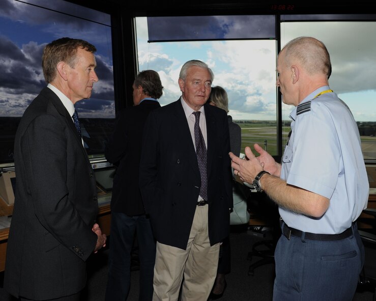 Royal Air Force Sqn. Ldr. Richard Fryer, right, RAF Mildenhall station commander, speaks with Lord Edward Leicester, center, husband of Lady Sarah Leicester, High Sheriff of Norfolk, and Sir Edward Greenwell, High Sheriff of Suffolk, Oct. 23, 2013, in the air traffic control tower on RAF Mildenhall, England. Local high sheriffs toured the base to learn more about its mission and how it affects the local community. (U.S. Air Force photo by Airman 1st Class Preston Webb/Released)