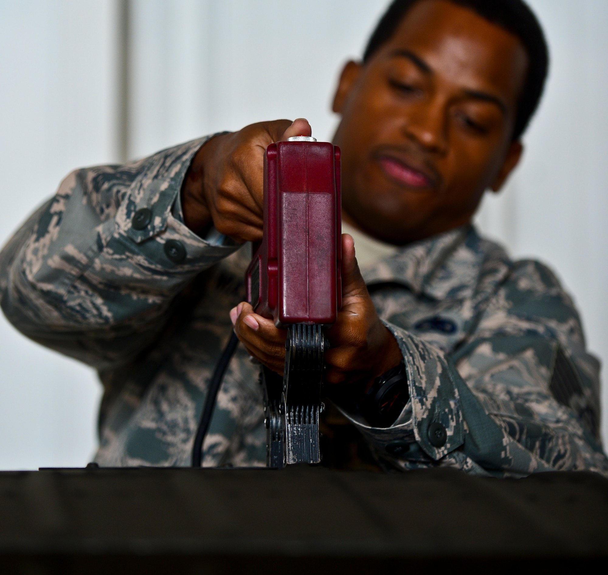 Tech. Sgt. Stanley Mays, 6th Maintenance Squadron nondestructive inspection specialist, demagnetizes an Army Blackhawk helicopter’s stabilator that was struck by lightning, Oct. 24, 2013, Clearwater Aviation Support Facility, Fla. After completing a series of specialized demagnetization procedures over the mounting section of the tail’s stabilator, the readings were returned to normal and the problem areas were neutralized. (U.S. Air Force photo by Staff Sgt. Brandon Shapiro/Released)