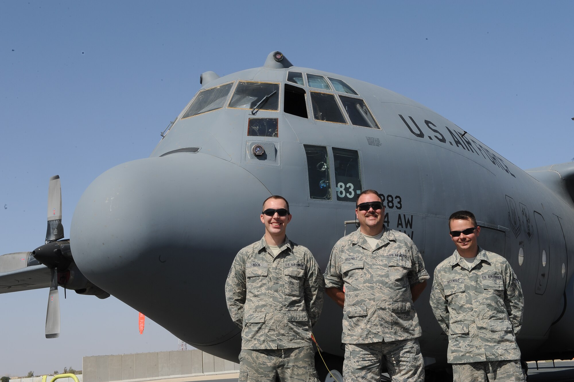Senior Master Sgt. Steven Buchwald is flanked by his son-in-law Senior Airman Hans Hock on his right and his son, Senior Airman Travis Buchwald, on his left as they stand proudly in front of a C-130 from their home unit, the 107th Airlift Wing, Air National Guard, Niagara Falls, N.Y. The trio are deployed together to the 386th Expeditionary Maintenance Group, undisclosed location, Southwest Asia.  The senior Buchwald retires in December after 32 years of military service and is thankful that he got to share it with family.   “It’s neat to be here with the two boys,” he said.  The Buchwalds are natives of Lockport, N.Y.  Hock is a native is Buffalo, N.Y.  (U.S. Air Force photo by Master Sgt. Marelise Wood)