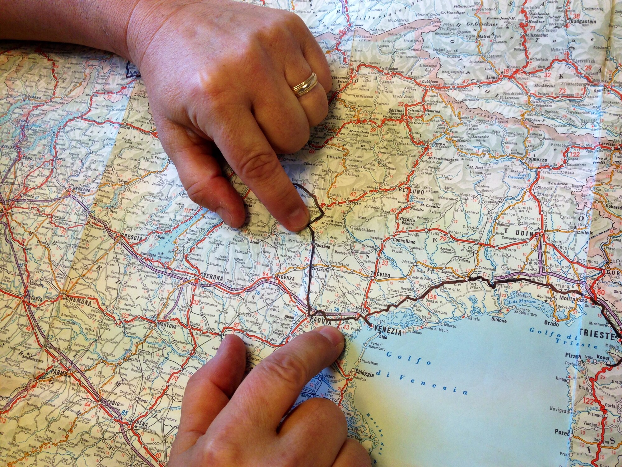 Mike Nishimuta points out the same 50-mile path from Venice to Bassano, Italy, that he once traveled in 1968 as a young man, Oct. 21, 2013 at Aviano Air Base, Italy. Originally, he got the idea to travel Europe by bicycle from an article in a 1955 issue of National Geographic magazine. (U.S. Air Force photo/Senior Airman Jessica Hines) 