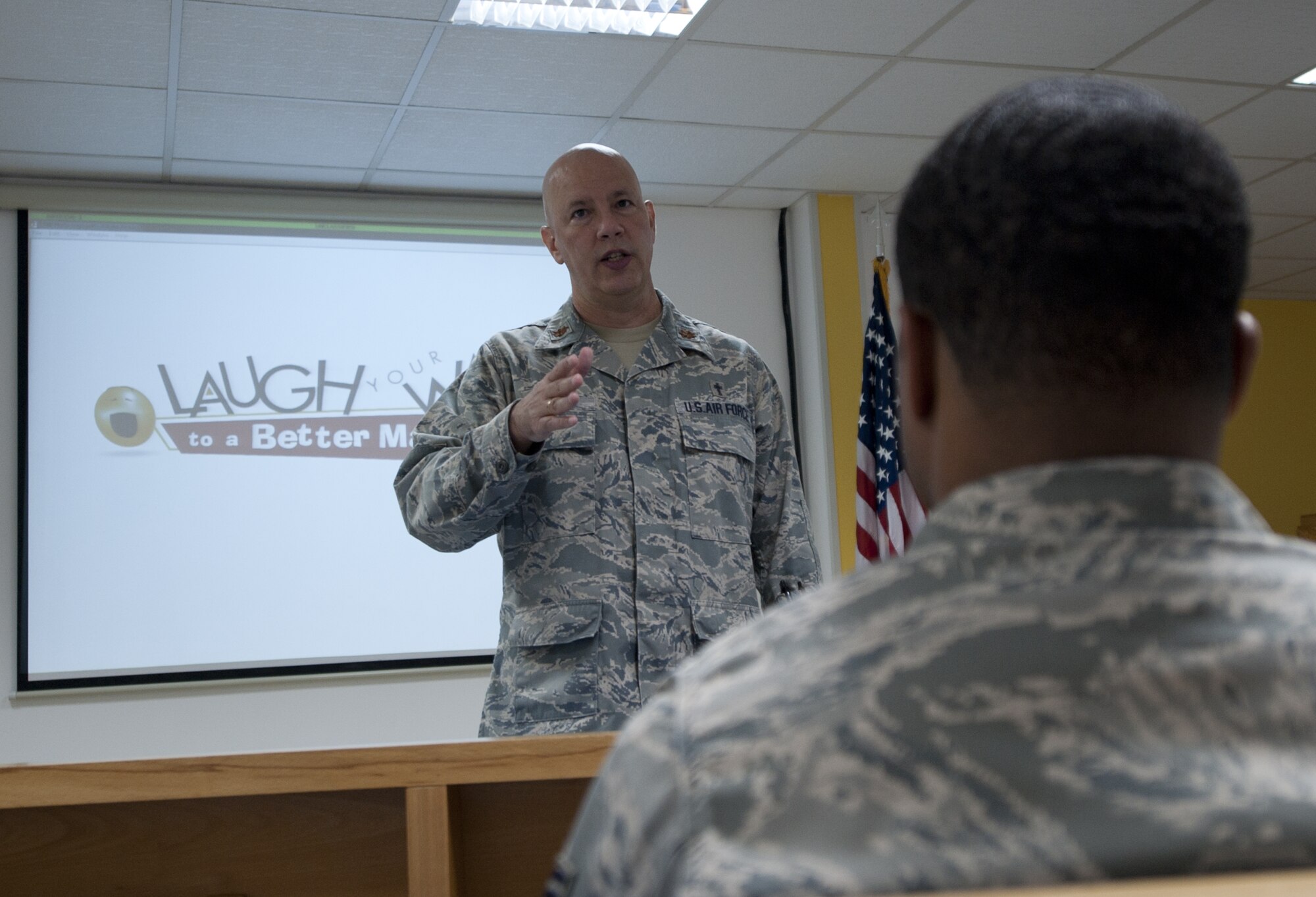 Chaplain (Maj.) Michael Howard, 380th Air Expeditionary Wing chaplain, speaks to an audience before a marriage enrichment class, “Laugh Your Way to a Better Marriage” at an undisclosed location in Southwest Asia Oct. 22, 2013. Howard held the class as a way to teach a larger audience how to better communicate in a relationship. Howard calls Memphis, Tenn., home and is deployed from Fairchild Air Force Base, Wash. (U.S. Air Force photo by Staff Sgt. Jacob Morgan)