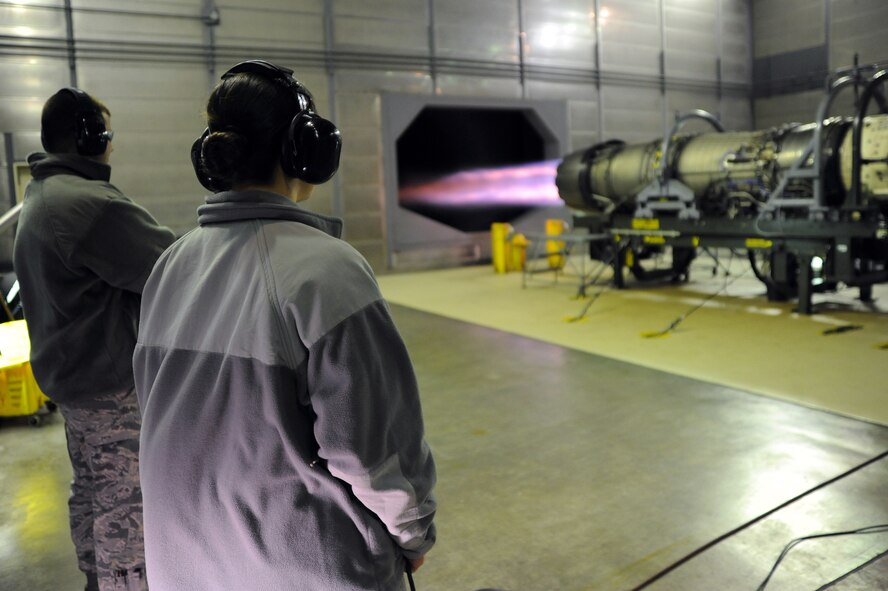 U.S. Air Force Airman 1st Class Matthew Jackson, left, and Senior Airman Brittney Rogerson, 35th Maintenance Squadron, oversee tests on an F110-GE-129 engine used for an F-16 Fighting Falcon at Misawa Air Base, Japan, Oct. 23, 2013. Jackson and Rogerson are part of the aerospace propulsion section, where they test an average of one engine every week. (U. S. Air Force photo by Senior Airman Derek VanHorn)