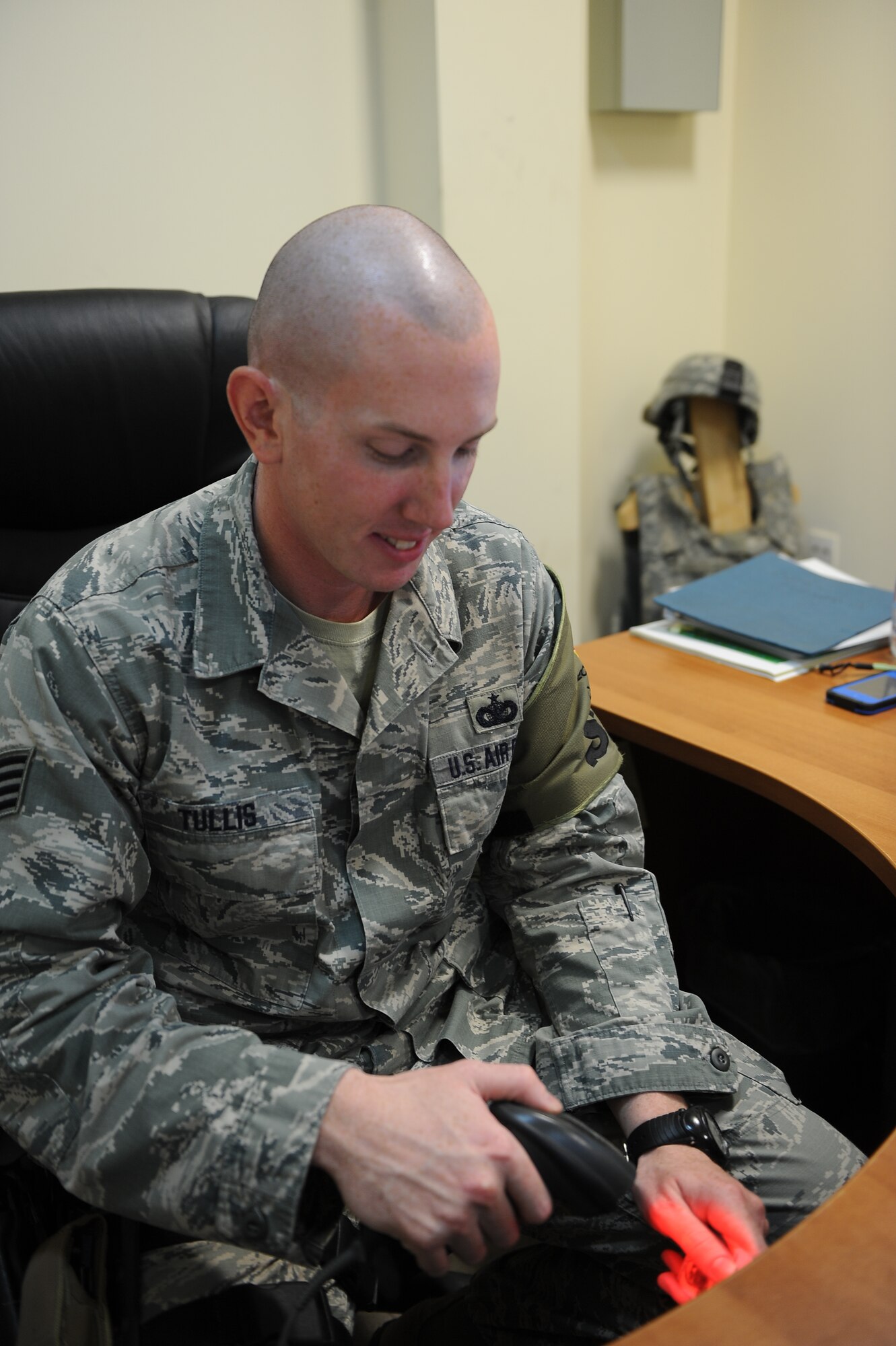 Staff Sgt. Chasin Tullis, 386th Expeditionary Security Forces Squadron scans a military common access card in the pass and registration office here, Oct. 24, 2013.  Tullis is the noncommissioned officer in charge of pass and registration where he serves as the authority for granting access to the base.  Tullis is on his third deployment having previously been to Iraq and Afghanistan. He has been selected by his leadership as this week's Rock Solid Warrior.  Tullis is deployed from Tinker Air Force Base, Okla.  He is a native of Hominy, Okla.  (U.S. Air Force photo by Master Sgt. Marelise Wood)