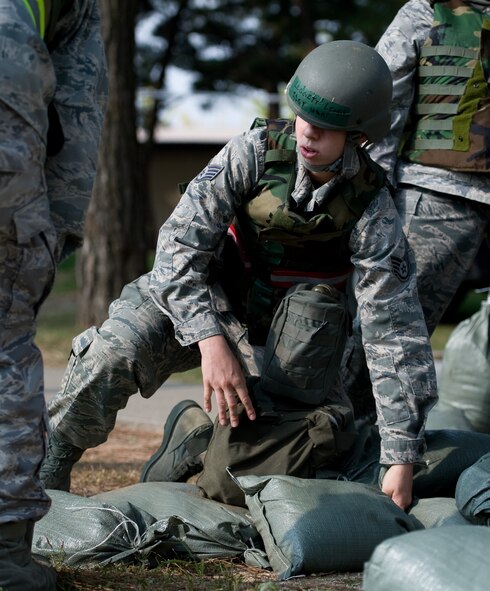 Staff Sgt. Lindy Leggett, 8th Civil Engineer Squadron dorm manager, helps construct a defensive fighting position during a training exercise at Kunsan Air Base, Republic of Korea, Oct. 24, 2013. Airmen from the 8th CES trained with the 8th Security Forces Squadron on how to defend their compound. The 8th SFS trained the Red Devils on communication tactics, apprehending suspects and manning defensive positions. (U.S. Air Force photo by Senior Airman Armando A. Schwier-Morales/Released)