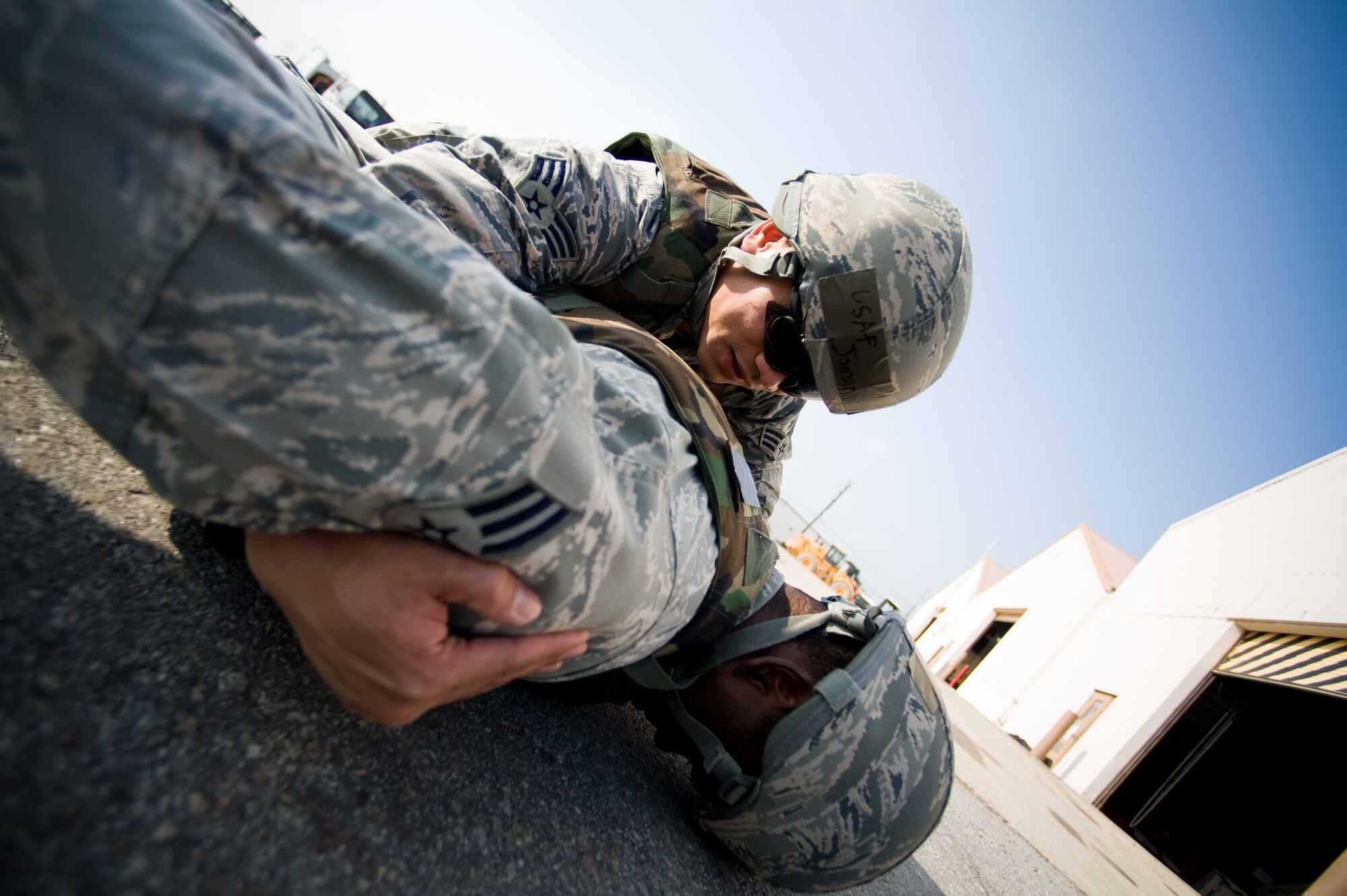 Senior Airman Jomar Perez, 8th Civil Engineer Squadron, rolls over a “suspect” to conduct a search during a training exercise at Kunsan Air Base, Republic of Korea, Oct. 24, 2013. Airmen from the 8th CES trained with the 8th Security Forces Squadron on how to defend their compound. The 8th SFS trained the Red Devils on communication tactics, apprehending suspects and manning defensive positions. (U.S. Air Force photo by Senior Airman Armando A. Schwier-Morales/Released)