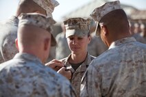 Gunnery Sgt. Robin Baker, a Mineral Point, Wis., native and combat engineer with Combat Logistics Regiment 2, Regional Command (Southwest), pins on the rank of gunnery sergeant during a promotion ceremony at Camp Leatherneck, Afghanistan, Oct. 1, 2013. Baker became the first female to earn the rank of gunnery sergeant in her military specialty after more than a decade of service.
