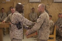Sgt. Maj. Paul Archie (left), the guest of honor at the Corporals Course graduation for Combat Logistics Regiment 2, Regional Command (Southwest), presents a graduating certificate to Cpl. Jason Pickerill, an Evansville, Ind., native and class honor graduate during a ceremony at Camp Leatherneck, Afghanistan, Oct.11, 2013. The regiment recognized Pickerill for his outstanding performance in the course and overall mastery of all subject areas.