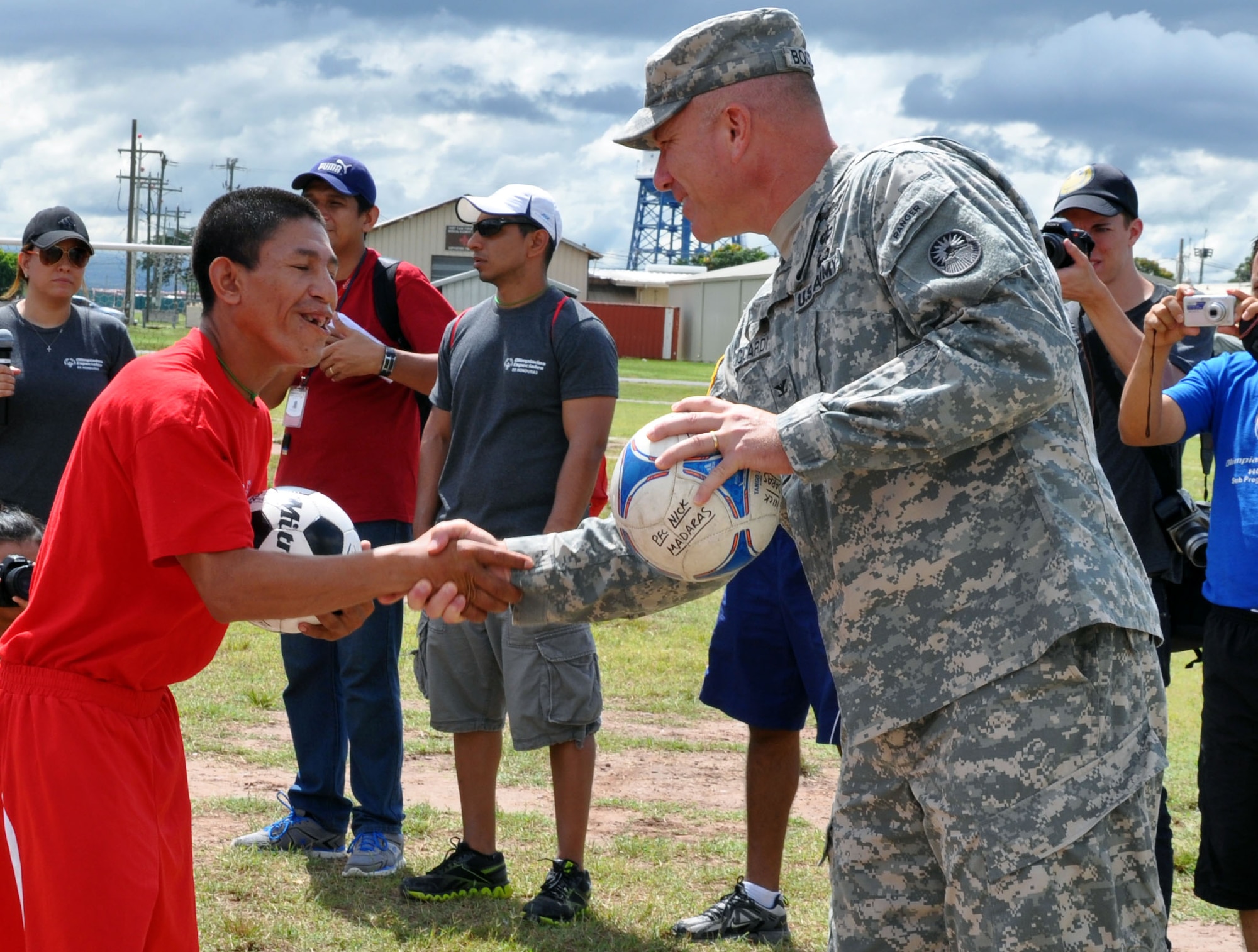 U.S. Army Col. Thomas Boccardi, Joint Task Force-Bravo commander, presents soccer balls to participants of the Honduras Special Olympics soccer tournament at Soto Cano Air Base, Honduras, Oct. 25, 2013.  Boccardi presented the balls as part of "Kick for Nick," a non-profit organization founded in honor of U.S. Army Pvt. Nick Madaras. While serving in Iraq in 2006, Madaras gathered soccer balls to give to underprivileged children near his post. However, he was killed and was never able to distribute the balls himself. Shortly after his death, the "Kick for Nick" organization was established in his honor. Today, soccer balls are donated and distributed to underprivileged children around the world through "Kick for Nick," in memory of Pvt. Madaras. (U.S. Air Force photo by Capt. Zach Anderson)