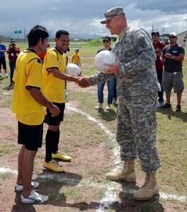 U.S. Army Col. Thomas Boccardi, Joint Task Force-Bravo commander, presents soccer balls to participants of the Honduras Special Olympics soccer tournament at Soto Cano Air Base, Honduras, Oct. 25, 2013.  Boccardi presented the balls as part of "Kick for Nick," a non-profit organization founded in honor of U.S. Army Pvt. Nick Madaras. While serving in Iraq in 2006, Madaras gathered soccer balls to give to underprivileged children near his post. However, he was killed and was never able to distribute the balls himself. Shortly after his death, the "Kick for Nick" organization was established in his honor. Today, soccer balls are donated and distributed to underprivileged children around the world through "Kick for Nick," in memory of Pvt. Madaras. (Photo by Martin Chahin)