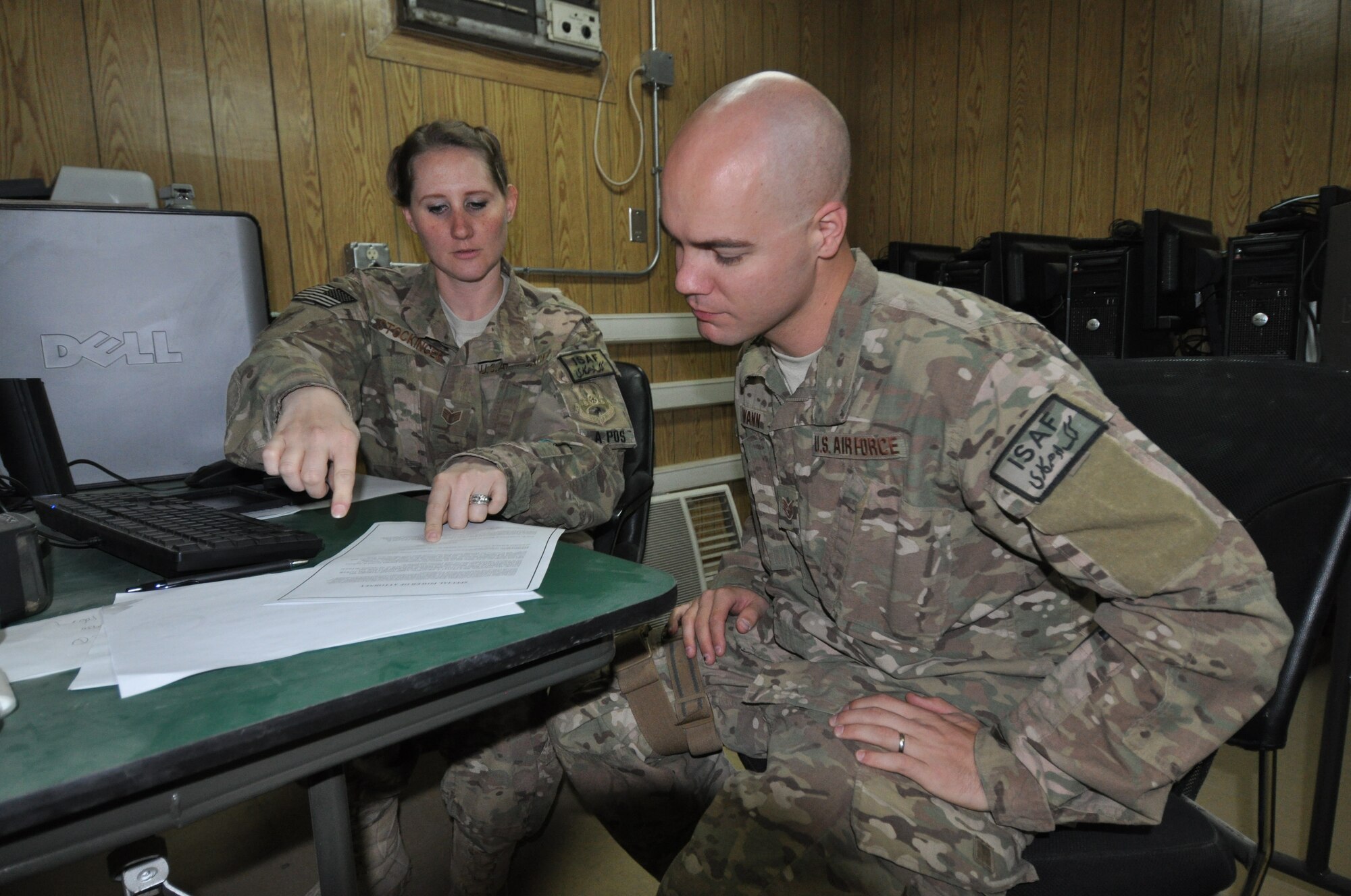Staff Sgt. Megan Stockinger, 455th Air Expeditionary Wing NCO in charge of military justice, deployed from Little Rock Air Force Base, Ark., and a native of Geneva, Ala., provides legal assistance to Staff Sgt. Lowell Wann, 455 AEW chaplain assistant, deployed from Buckley AFB, Colo., who is a native of Odessa, Mo., on Bagram Airfield, Afghanistan, Oct. 23, 2013. (U.S. Air Force photo/Tech. Sgt. Rob Hazelett)