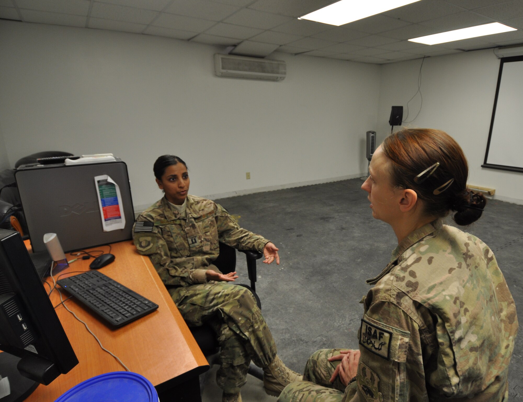 Capt. Dimple Nolly, 455th Air Expeditionary Wing Deputy Staff Judge Advocate, deployed from Spangdahlem Air Base, Germany, and a Houston native, provides legal assistance to Staff Sgt. Angela Smith, 455th Expeditionary Civil Engineer Squadron, deployed from Little Rock, Air Force Base, Ark, and a native of Bay, Ark., on Bagram Airfield, Afghanistan, Oct. 23, 2013. (U.S. Air Force photo/Tech. Sgt. Rob Hazelett)