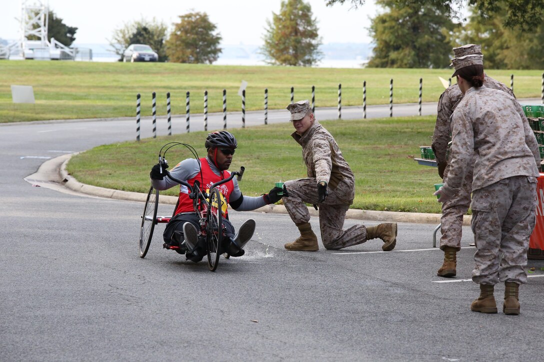 A participant approaches the half-way point during the Marine Corps Marathon in Washington, D.C., on Oct. 27, 2013. More than three dozen Marines and civilian volunteers were there to hand out water and Gatorade.