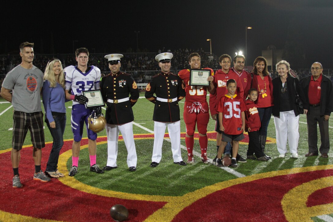 Kim Mahoney, a football player for St. Augustine High School and Brett Sarem, a football player for Cathedral Catholic High School, are presented the outstanding athlete award School before the start of the Great American Rivalry Series football game against St. Augustine High School at CCHS, San Diego, Oct. 25. Mahoney and Sarem were presented the award for outstanding academic performance as a football athlete. 