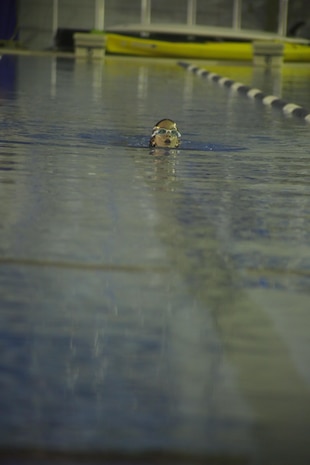 Samantha Johnston, 9, swims her final 238th lap for the Marine Corps Birthday Swim at the IronWorks Gym aboard Marine Corps Air Station Iwakuni, Japan, Oct. 25, 2013. Samantha swam 25 laps everyother day to complete the swim.